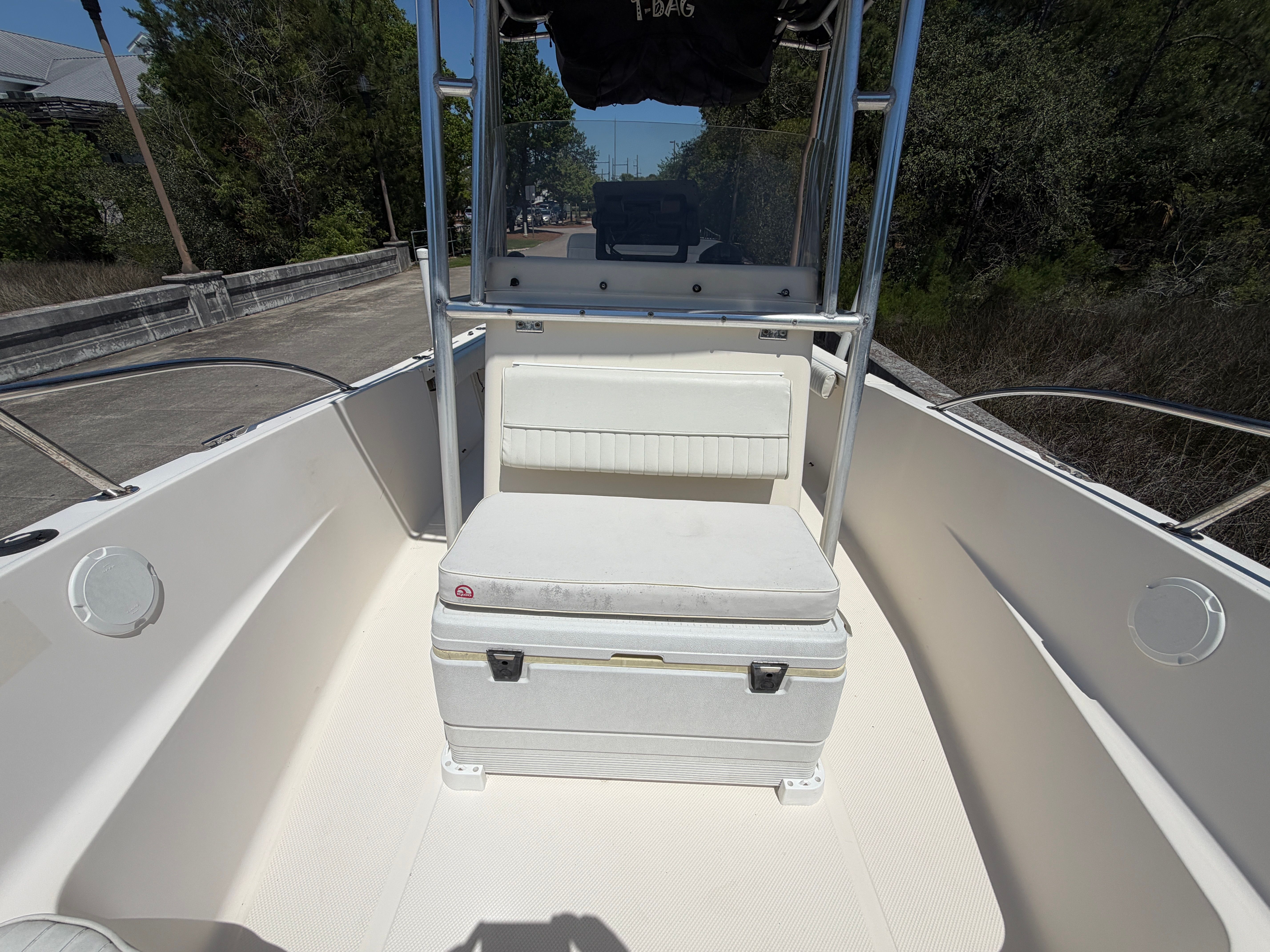 Key West 2020 Center Console boat, 2004 model, featuring seat and cooler.