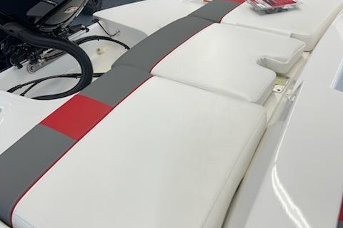 2025 Tahoe T21 boat interior with white, gray, and red cushioned seating.