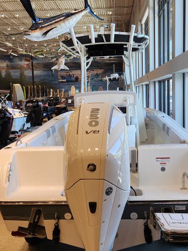 2025 Mako 214 CC boat with powerful V8 engine displayed indoors.