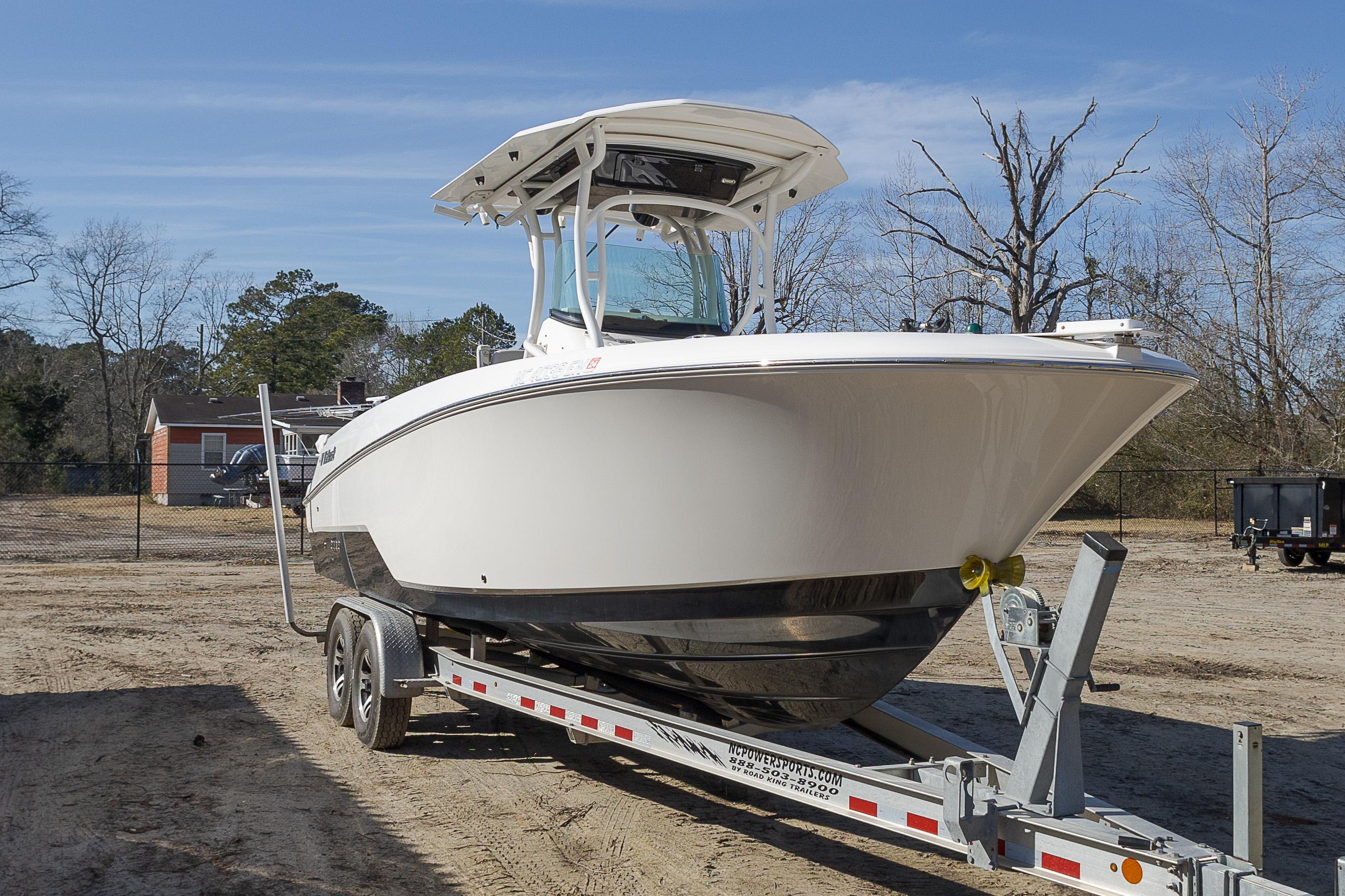 2019 Wellcraft 262 Fisherman boat on trailer, parked outdoors.