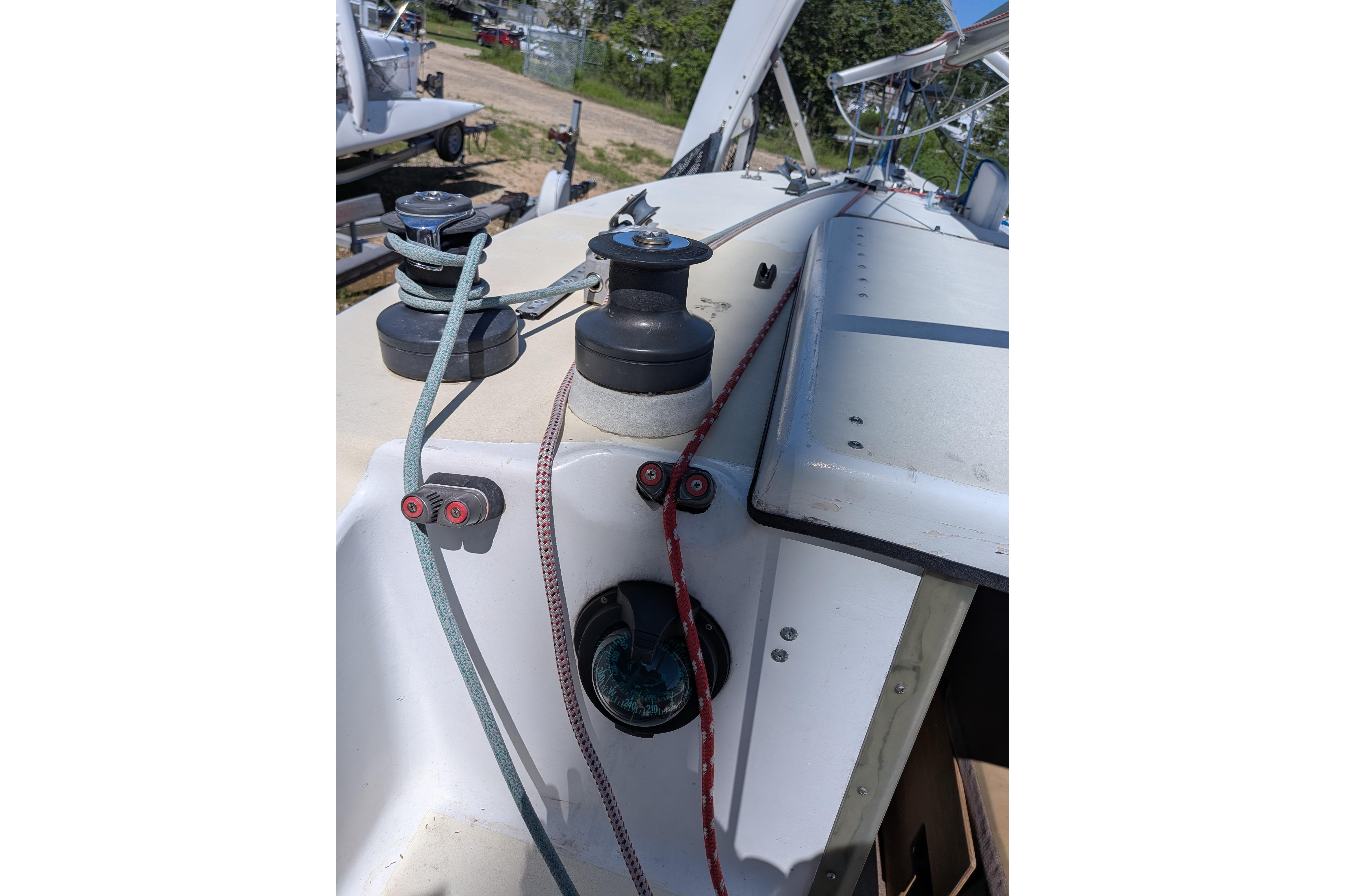 Close-up of 1991 Corsair F-27 sailboat deck with winches and ropes.