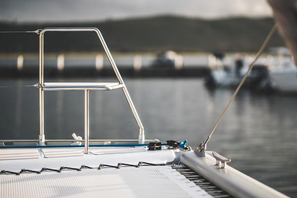 Sailboat deck with railing, Vision 444 model, 2025, docked at marina.
