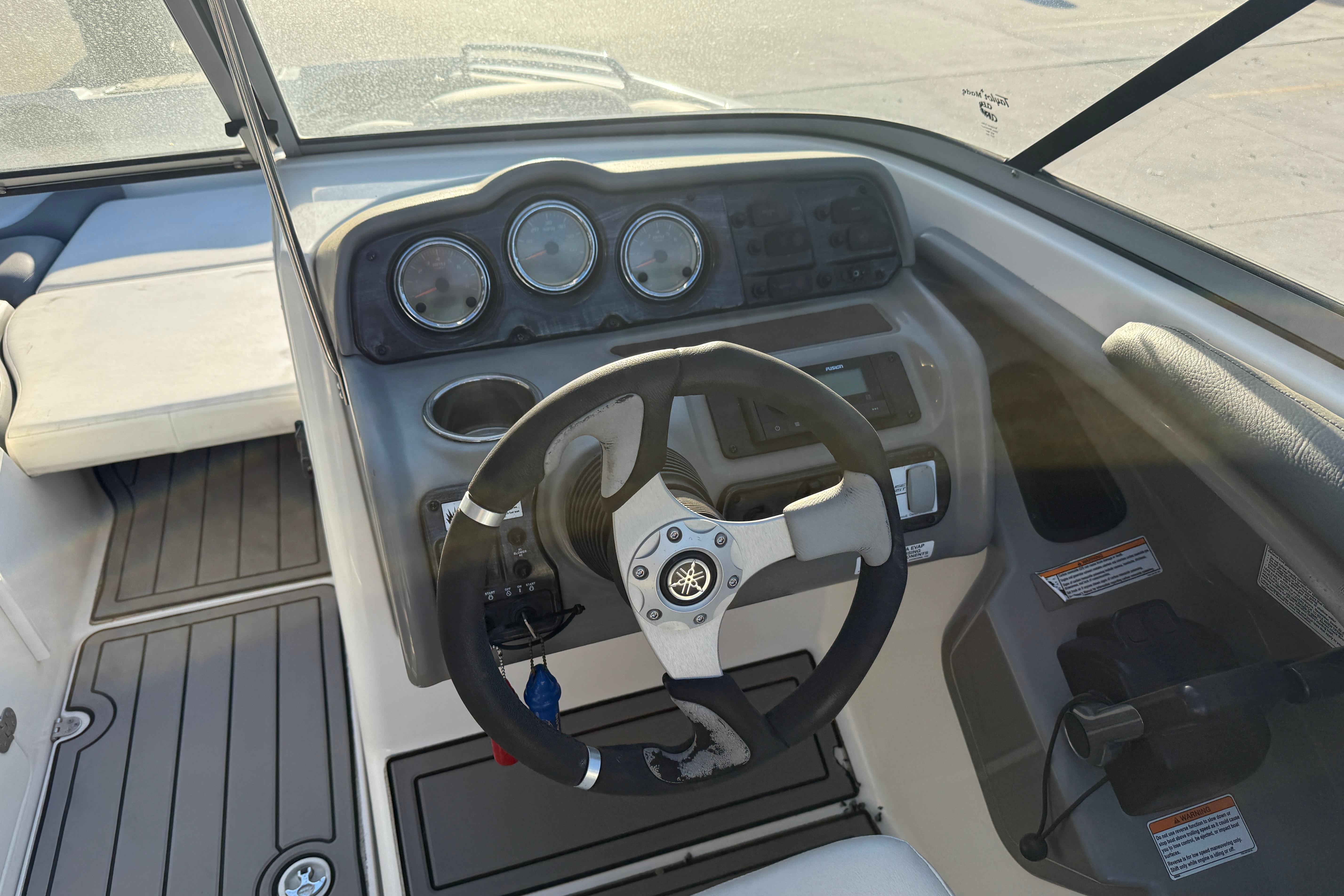 Steering console of 2011 Yamaha Boats 242 Limited S with gauges and controls.