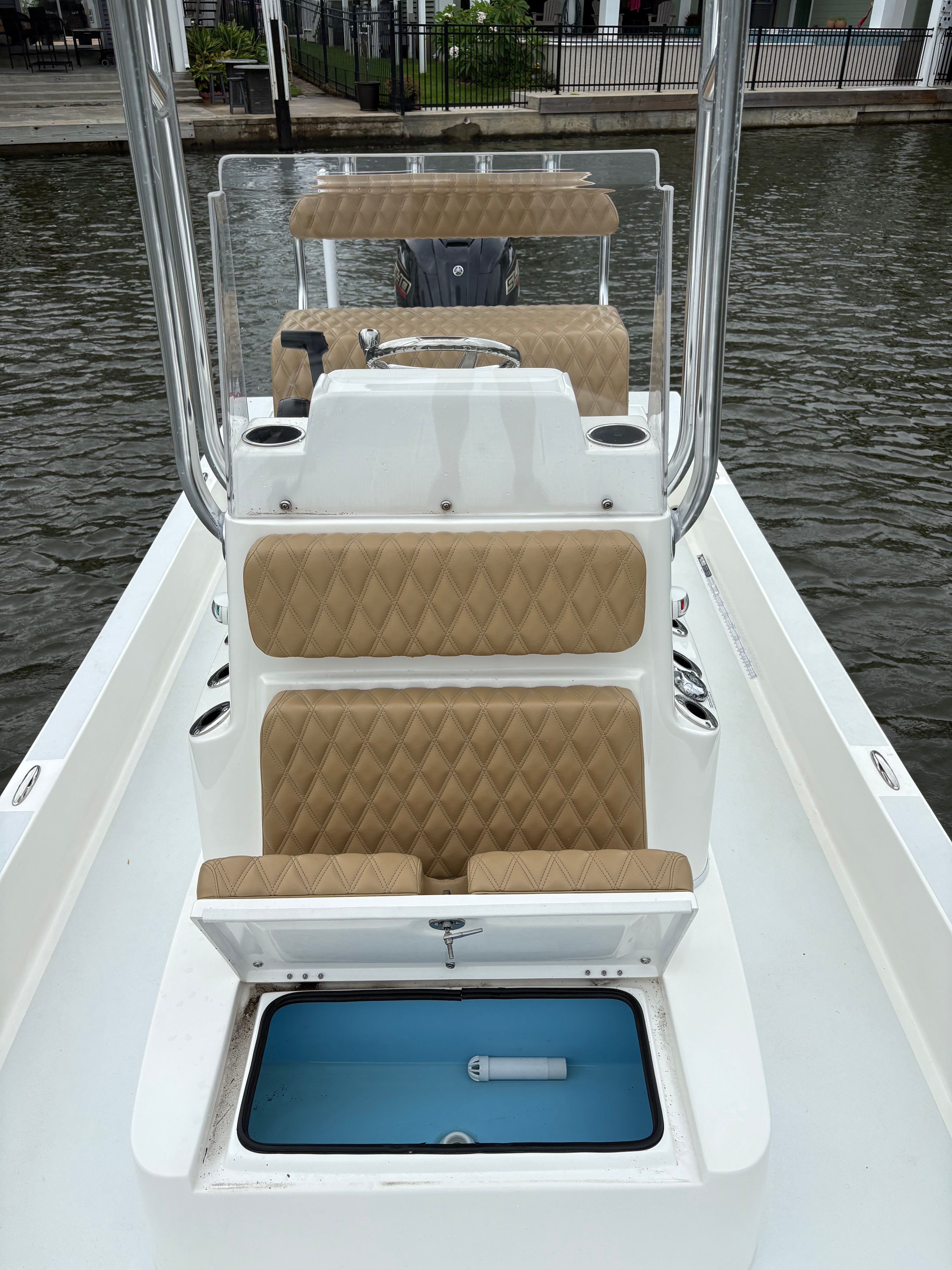 The image shows the cockpit of a Shallow Sport 24 Sport boat with beige upholstery.