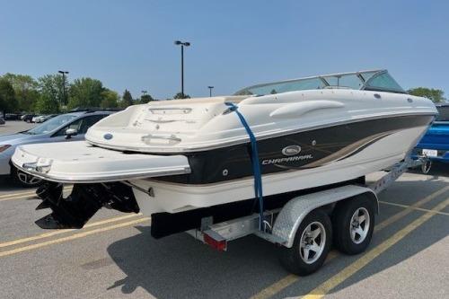 2006 Chaparral 220 SSi boat on trailer in parking lot.