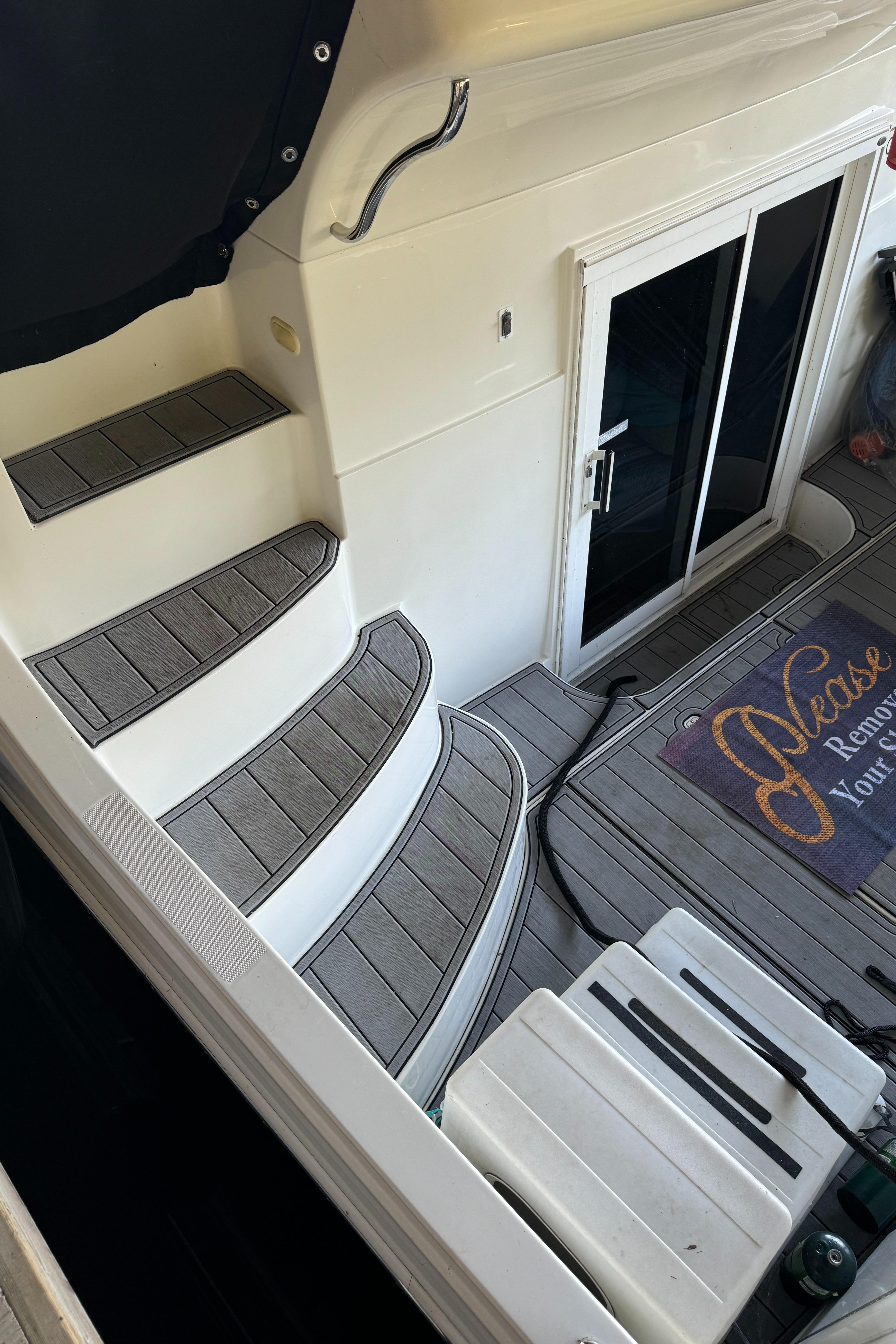 2005 Carver 41 Cockpit Motor Yacht stairs and deck with welcome mat.