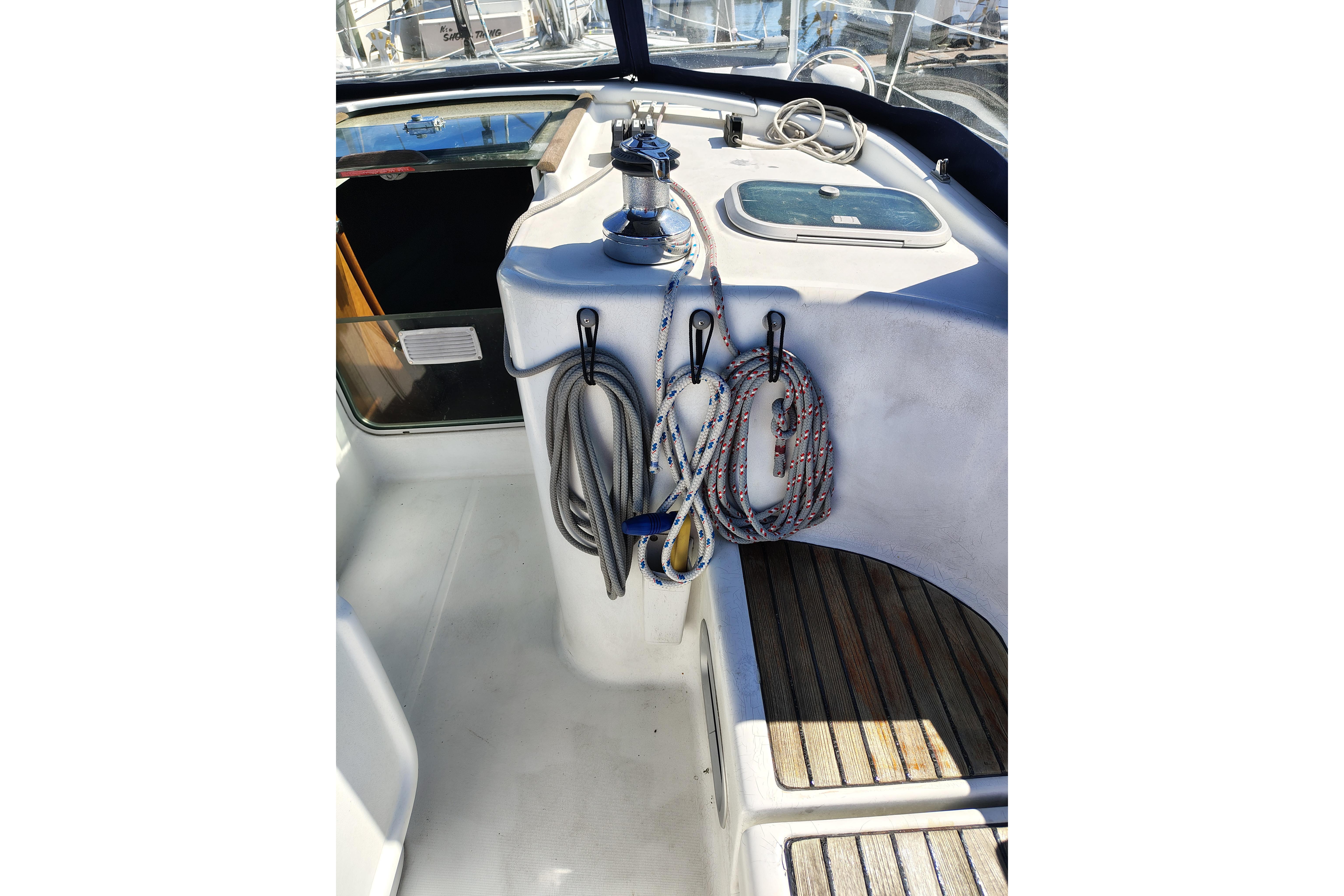 Cockpit of 2001 Beneteau Oceanis 411 sailboat with ropes and winch.