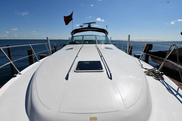 1997 Sea Ray 400 Sundancer yacht on water, clear sky, docked at marina.