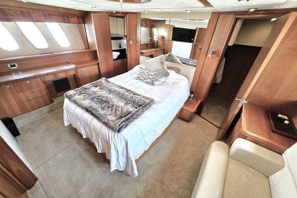 Luxurious cabin interior of 2005 Sunseeker Manhattan 66 yacht with elegant wood finishes.