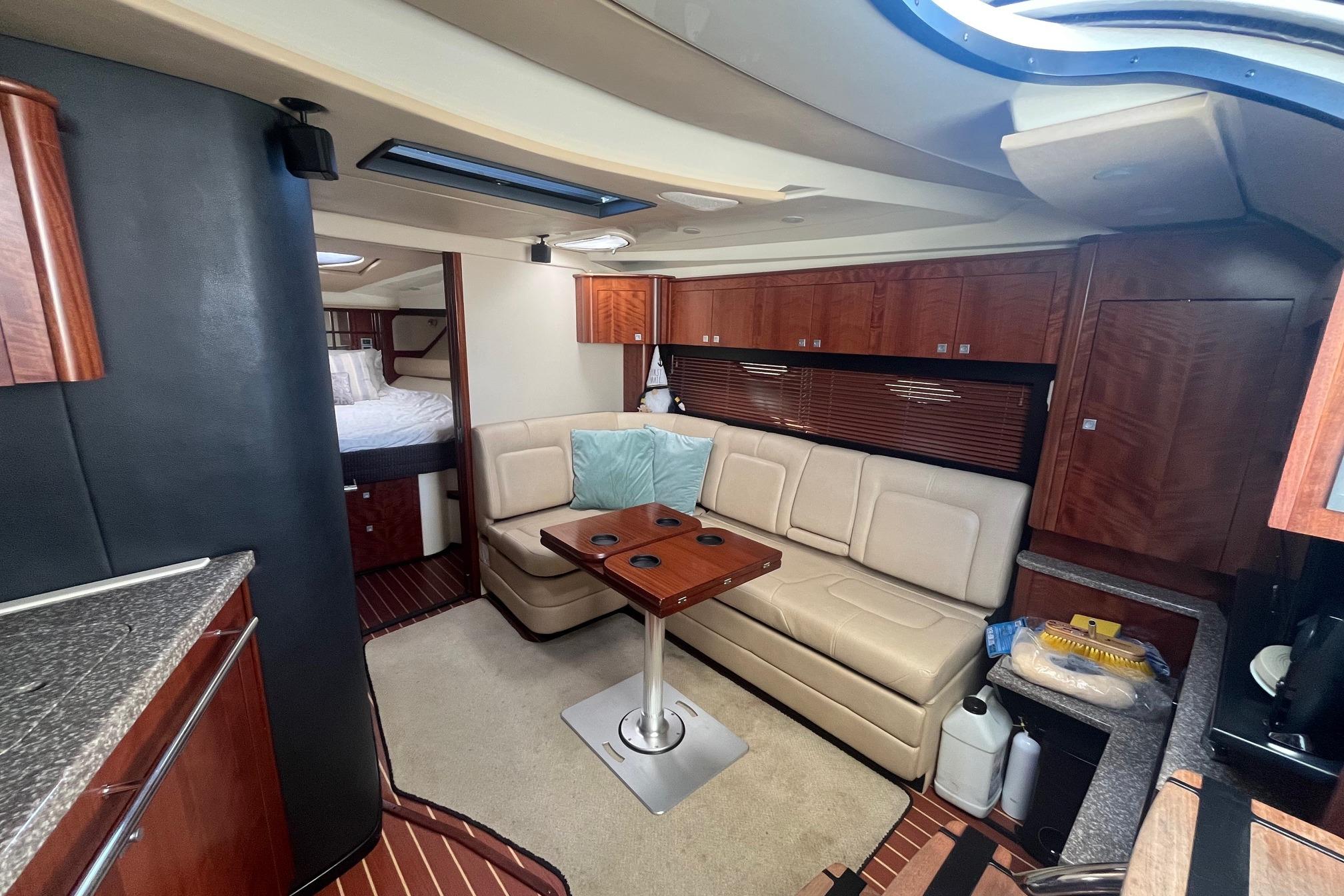 Luxurious interior of 2010 Monterey 400 Sport Yacht with leather seating and wooden cabinetry.
