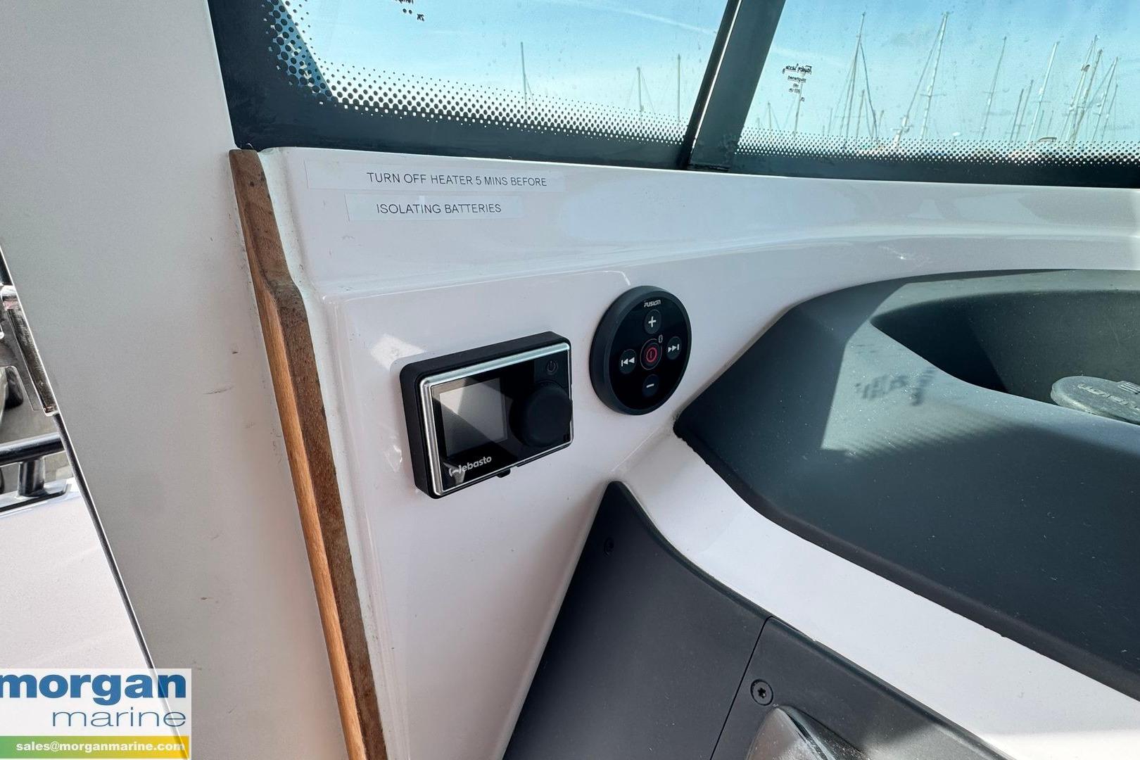 Control panel inside 2021 Axopar 28 Cabin boat, featuring heater and battery isolation instructions.