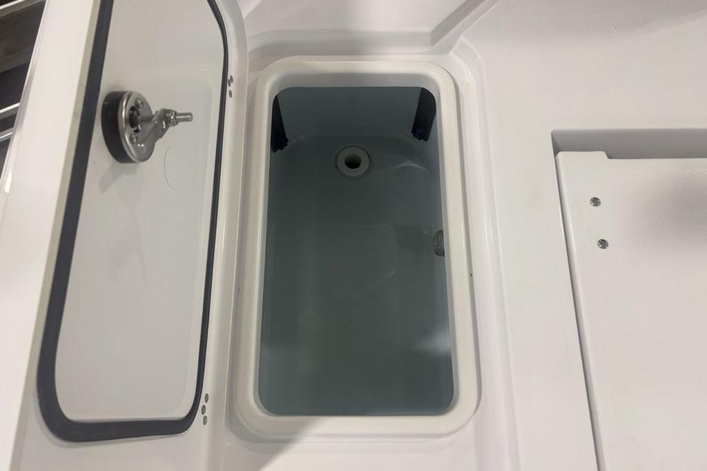 Livewell compartment in 2026 Sportsman Masters 227 boat, open lid view.