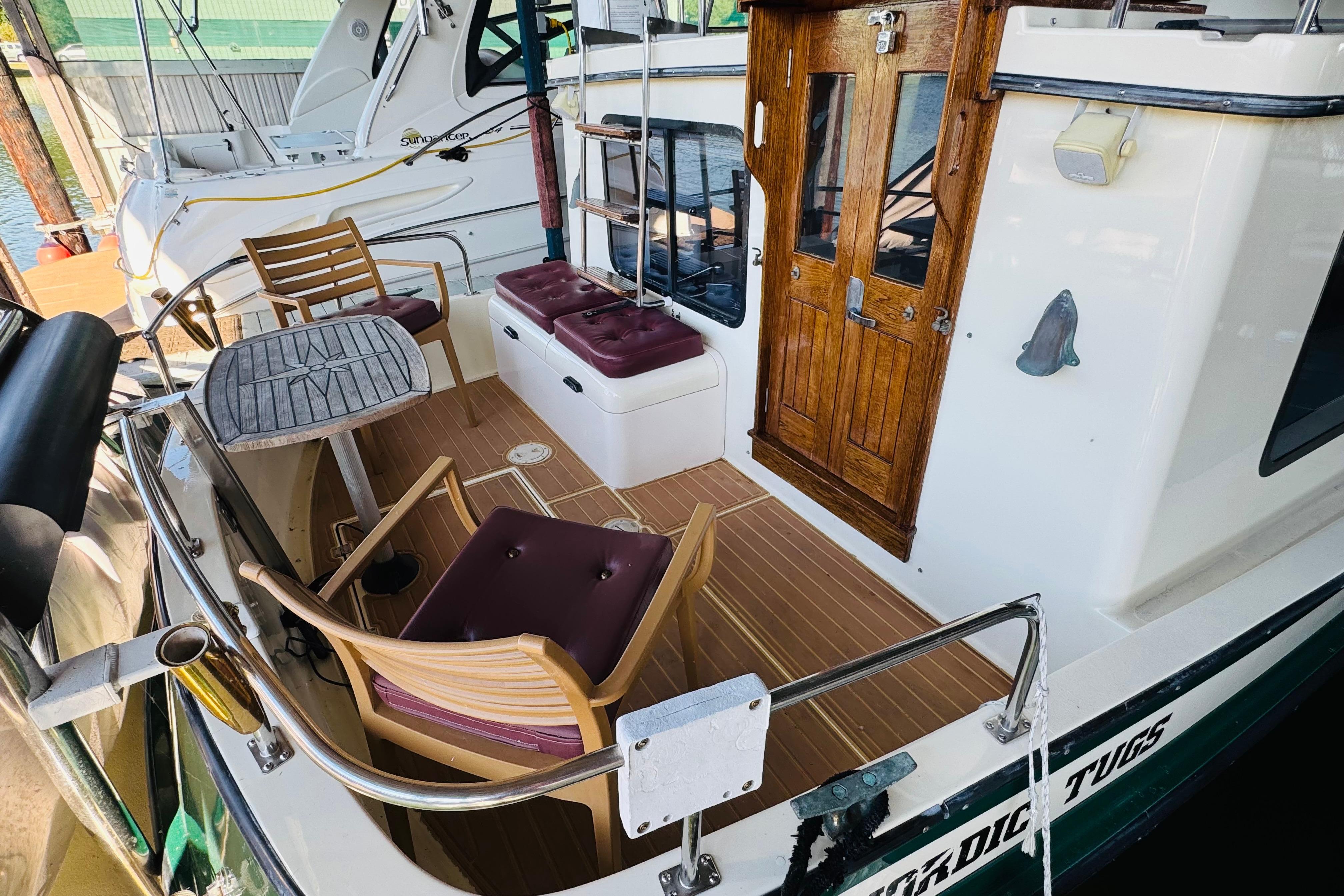 Nordic Tug 32, 1996 model, featuring a wooden deck and seating area.