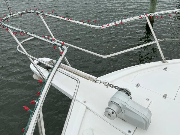 Novatec Islander 55 yacht bow with railing and festive lights, 2000 model.