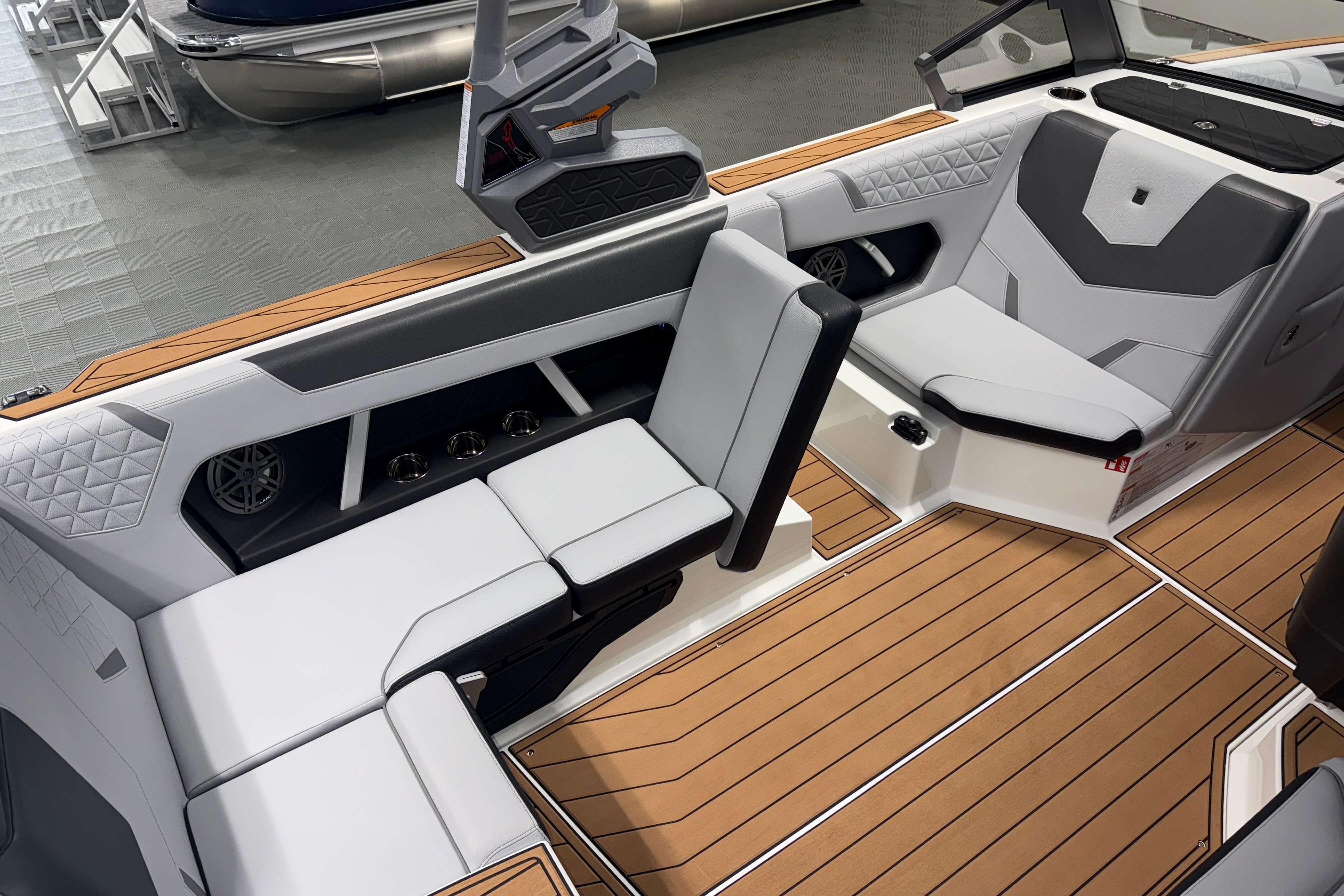 2026 Nautique Super Air Nautique GS22 interior with modern seating and teak flooring.