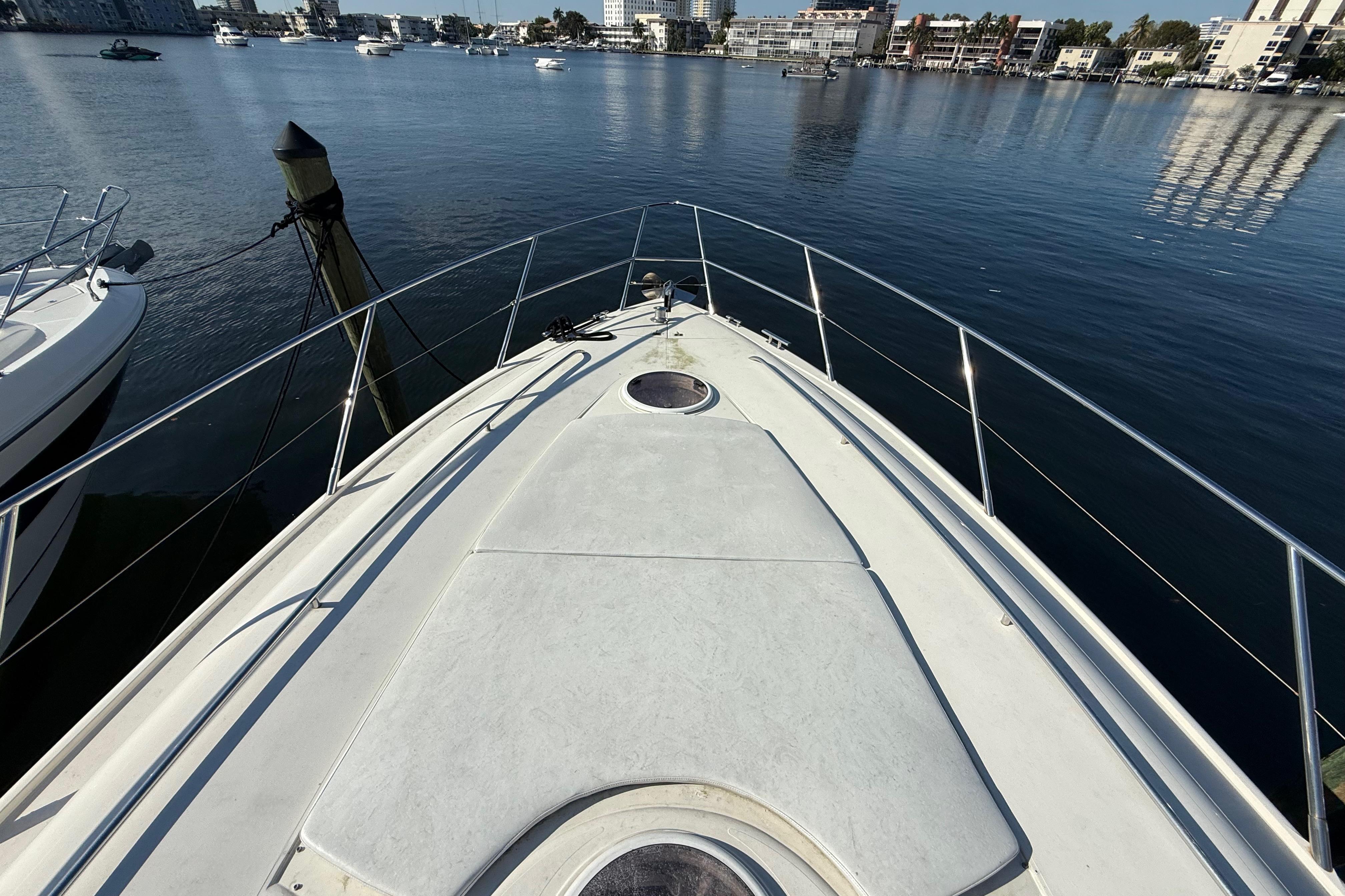 Bow view of 2002 Viking Princess V50 yacht docked in a marina.
