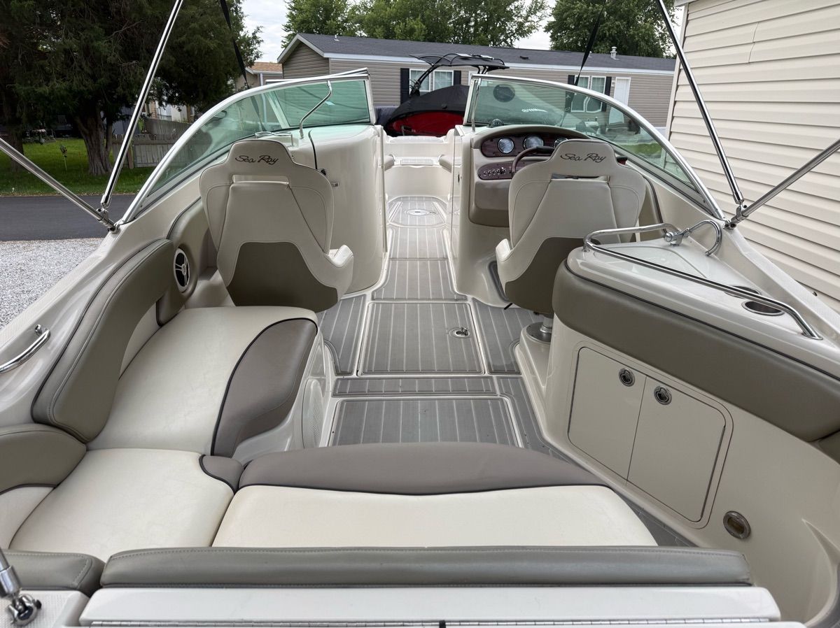 The image shows the interior of a 2007 Sea Ray 240 Sundeck boat with beige seating.