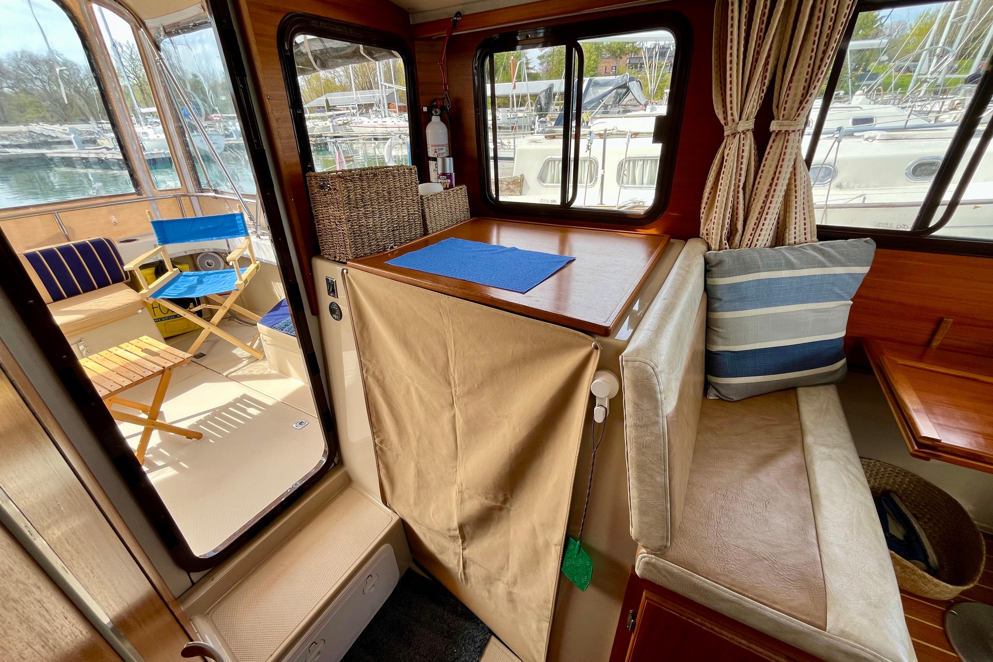 Interior of a 2013 Ranger Tugs R-27 boat with seating and outdoor view.