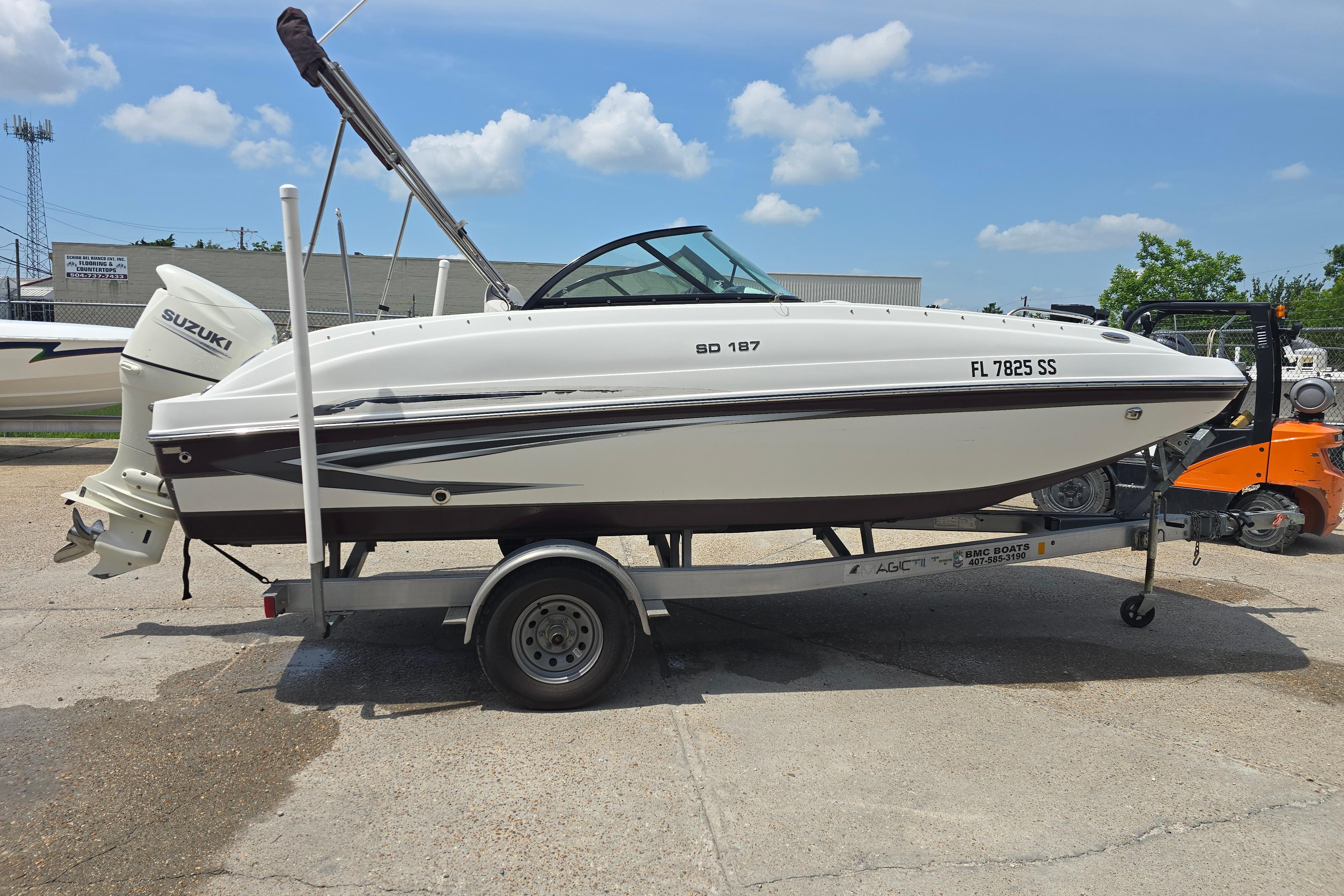 2020 Hurricane SunDeck 187 OB boat on trailer, featuring Suzuki outboard motor.