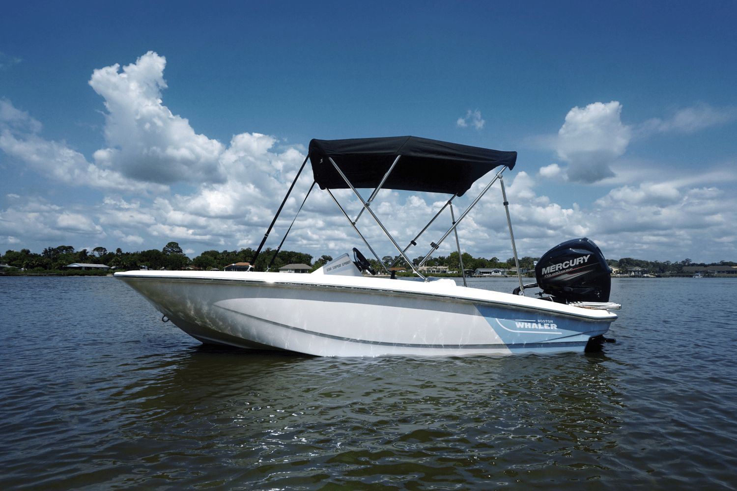 Boston Whaler 130 Super Sport 2026 on calm water with a black sunshade.