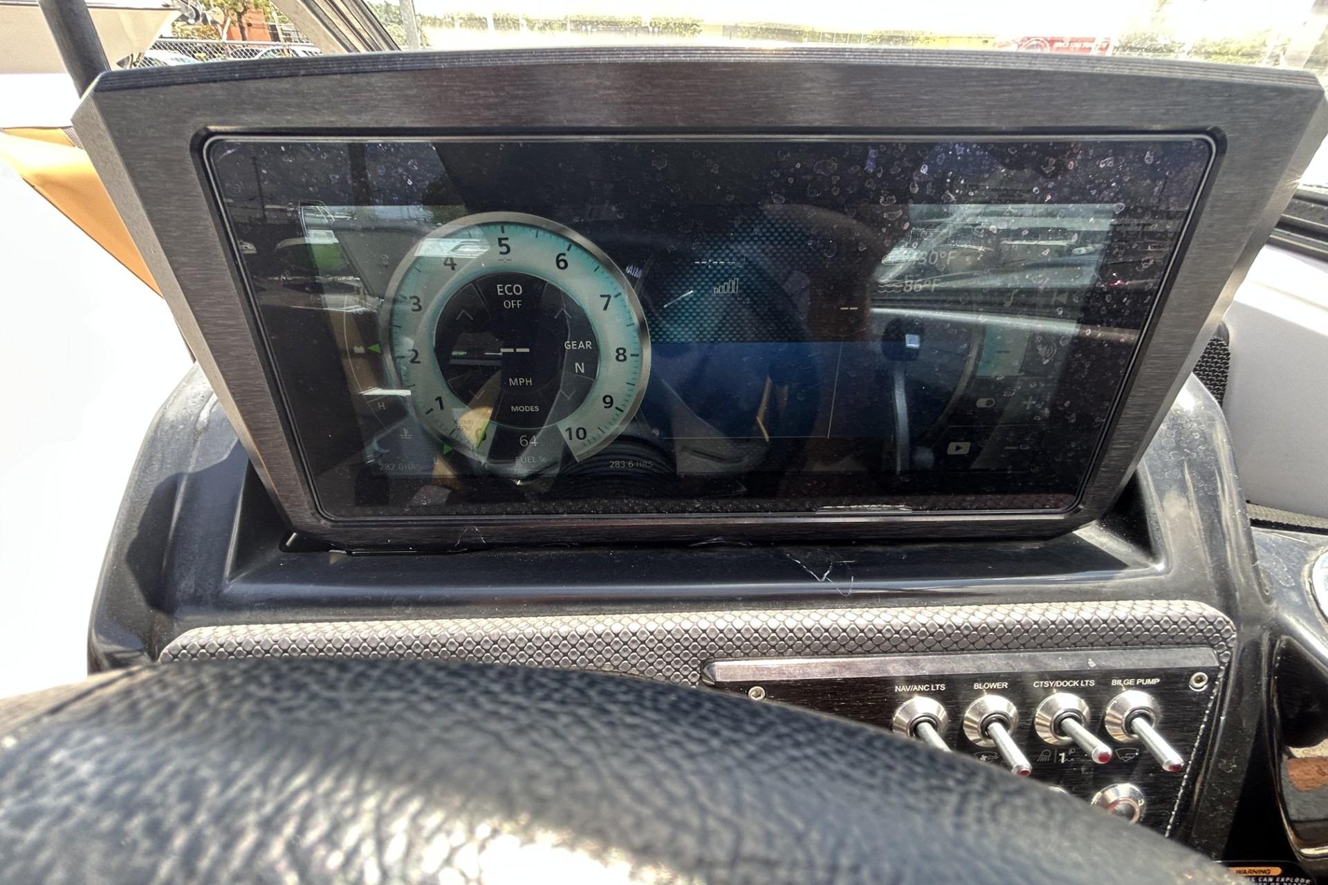 Dashboard of a 2019 Scarab 255 ID boat with digital display and control switches.