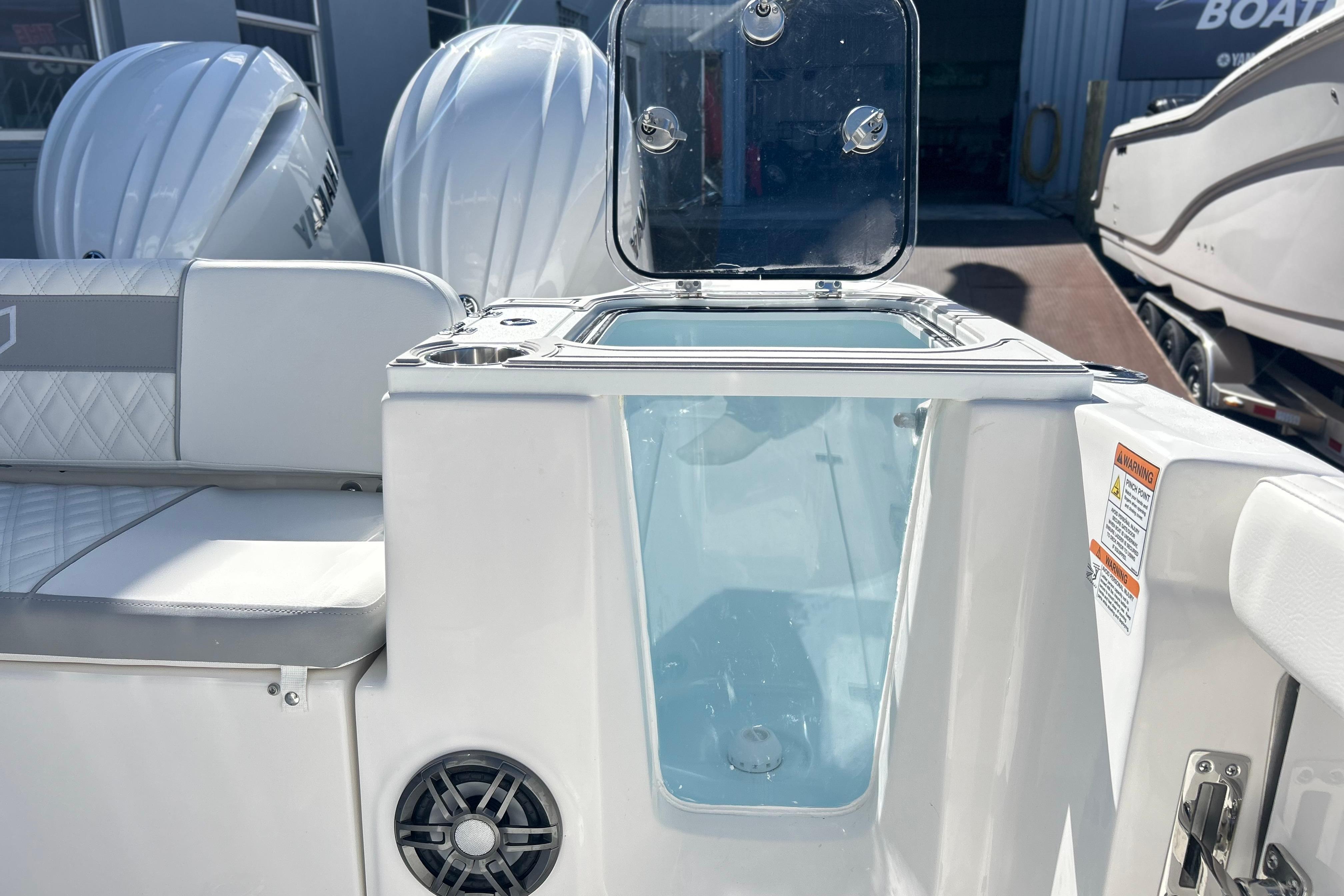2026 Sea Fox 268 Commander boat interior with open storage compartment and Yamaha engines.
