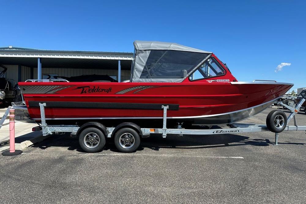 2026 Weldcraft 240 Maverick DV boat on trailer, red exterior, parked outdoors.