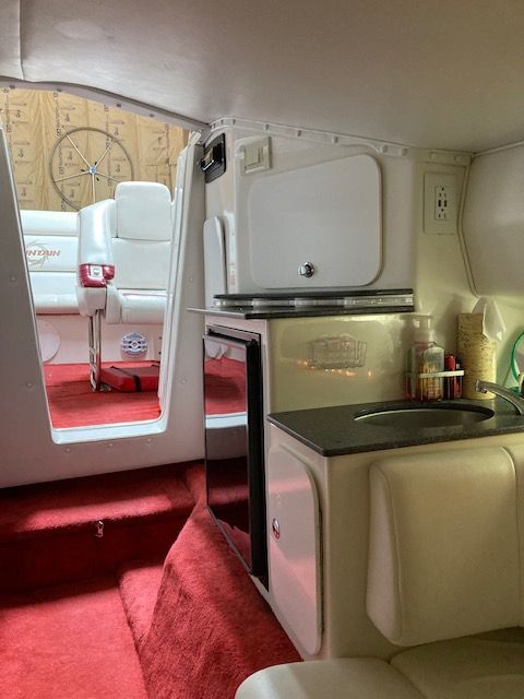 Interior of a 2001 Fountain Lightning boat with red carpet.