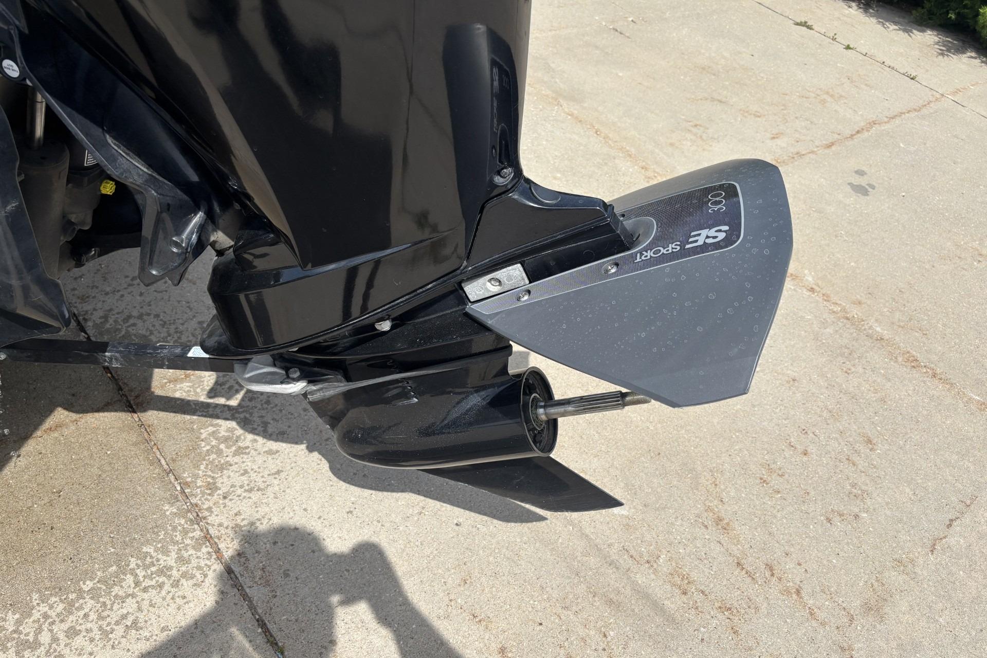 1999 Tracker Targa 18 boat motor with SE Sport hydrofoil on concrete surface.