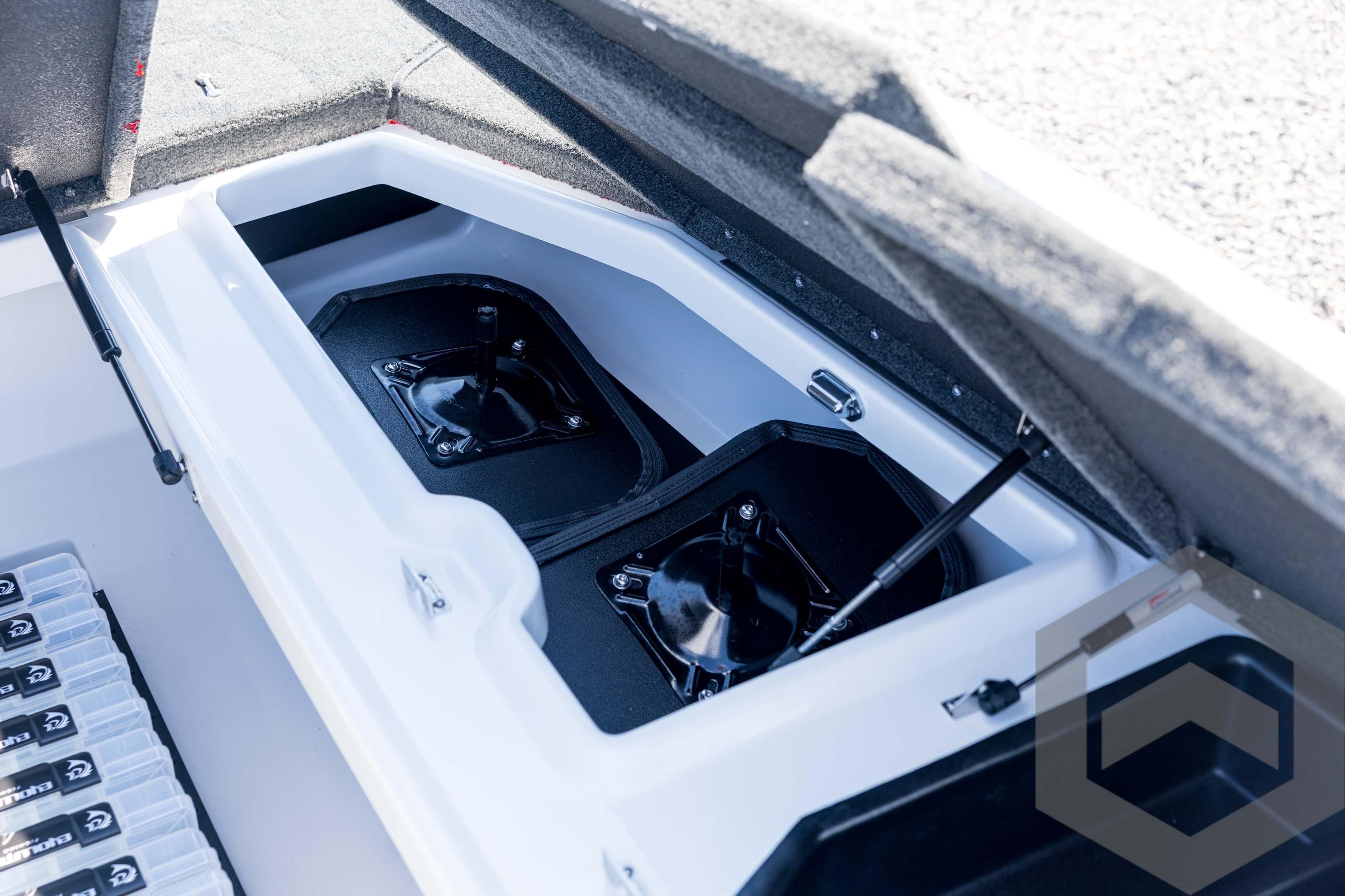 2026 Skeeter ZXE21 boat storage compartment with organized tackle boxes and hydraulic lift.