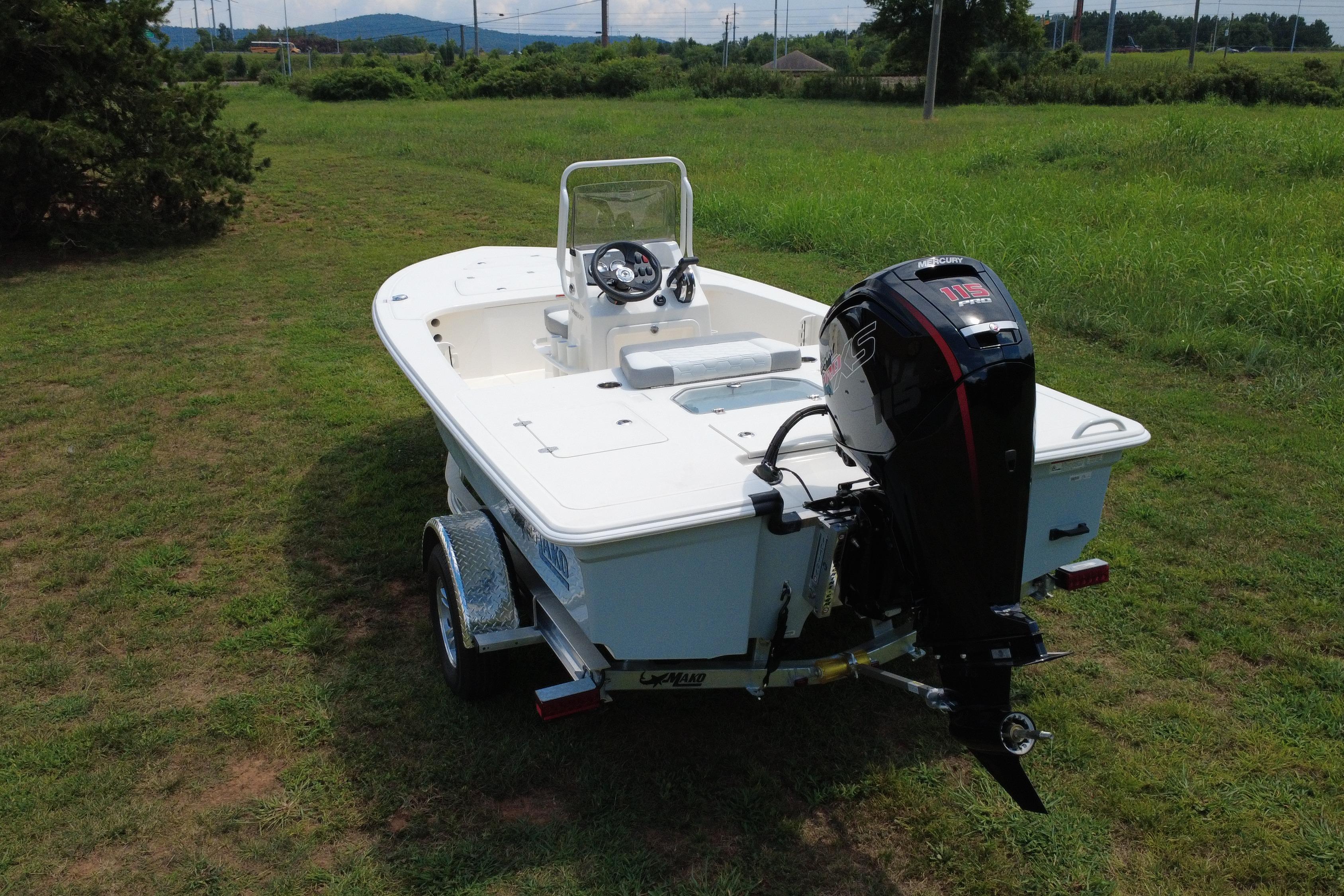 2026 Mako 18 Pro Skiff boat on trailer, grassy field background.