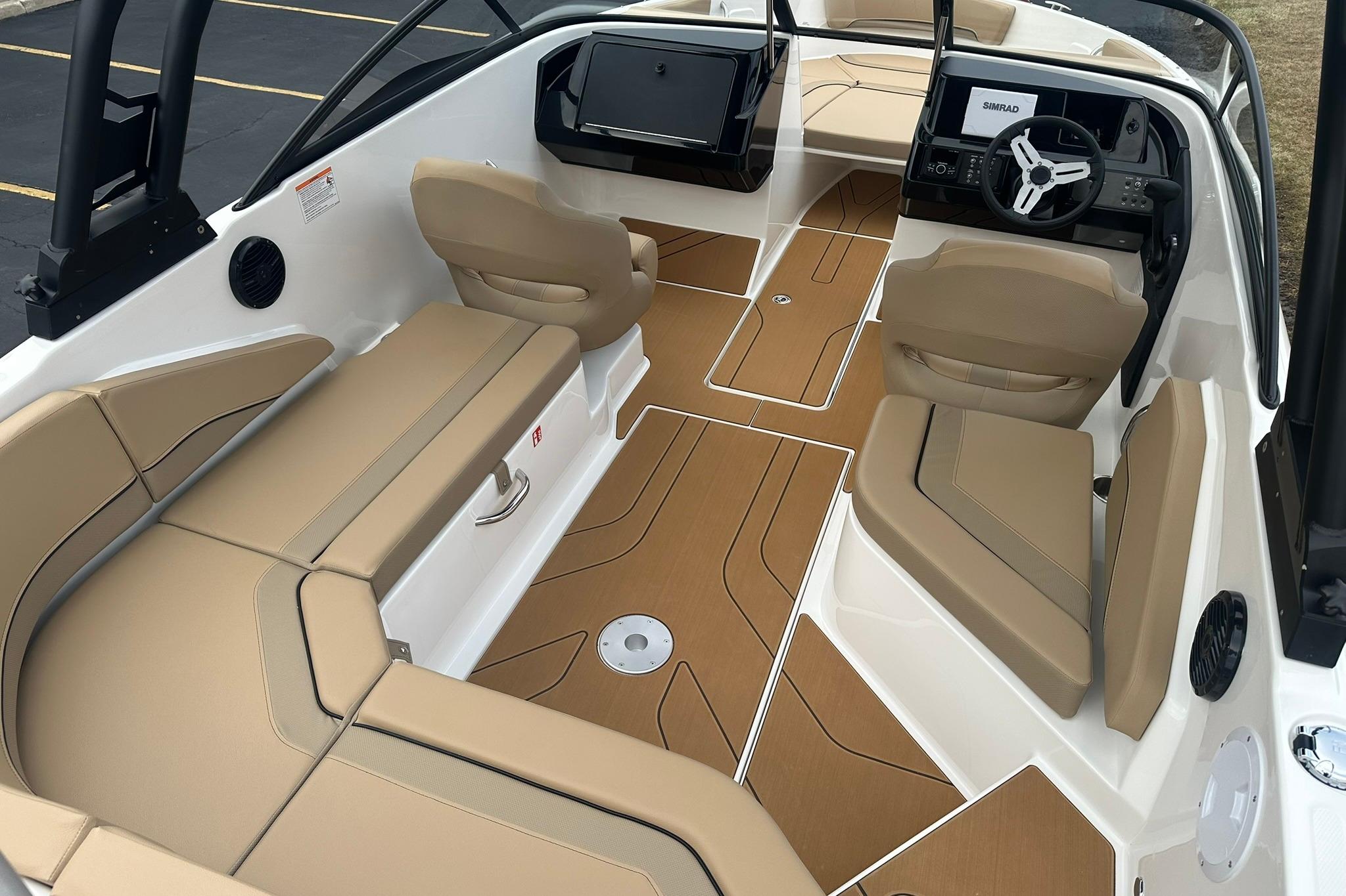 2026 Bayliner V20 boat interior with tan seating and modern dashboard.