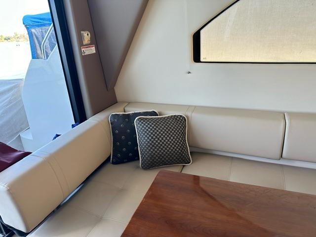 Interior of 2016 Carver C34 Command Bridge with cushioned seating and decorative pillows.