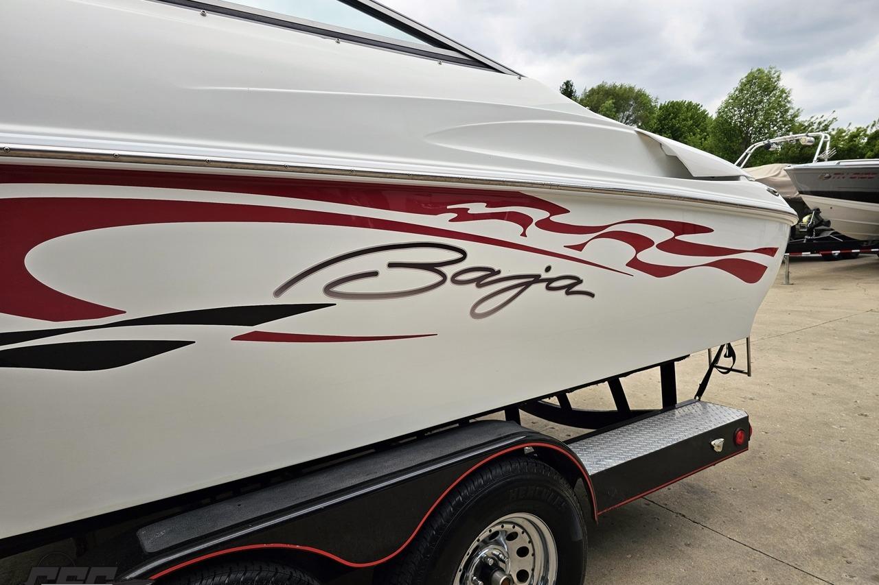 2004 Baja 275 boat with red and black graphics on a trailer.
