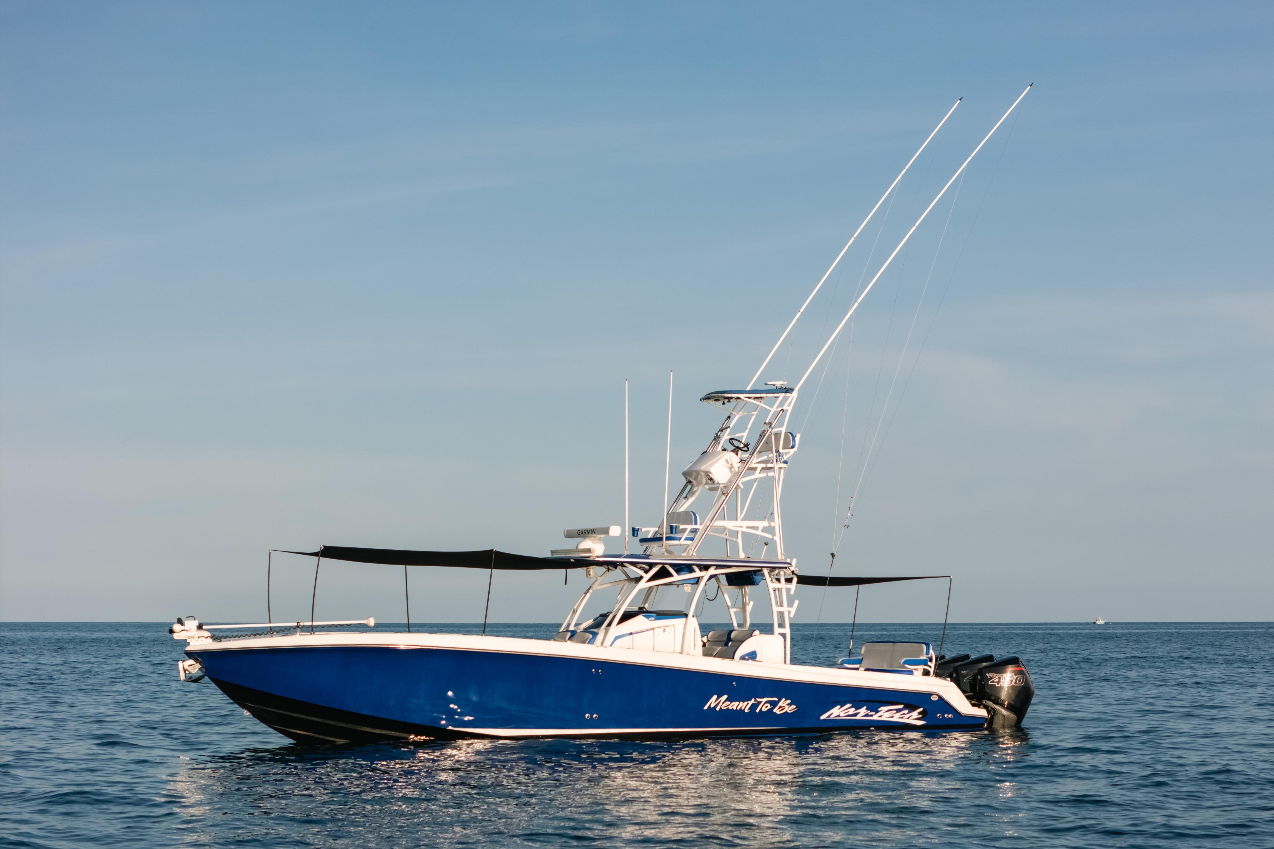 2022 Nor-Tech 392 Super Fish boat on calm ocean waters under clear sky.