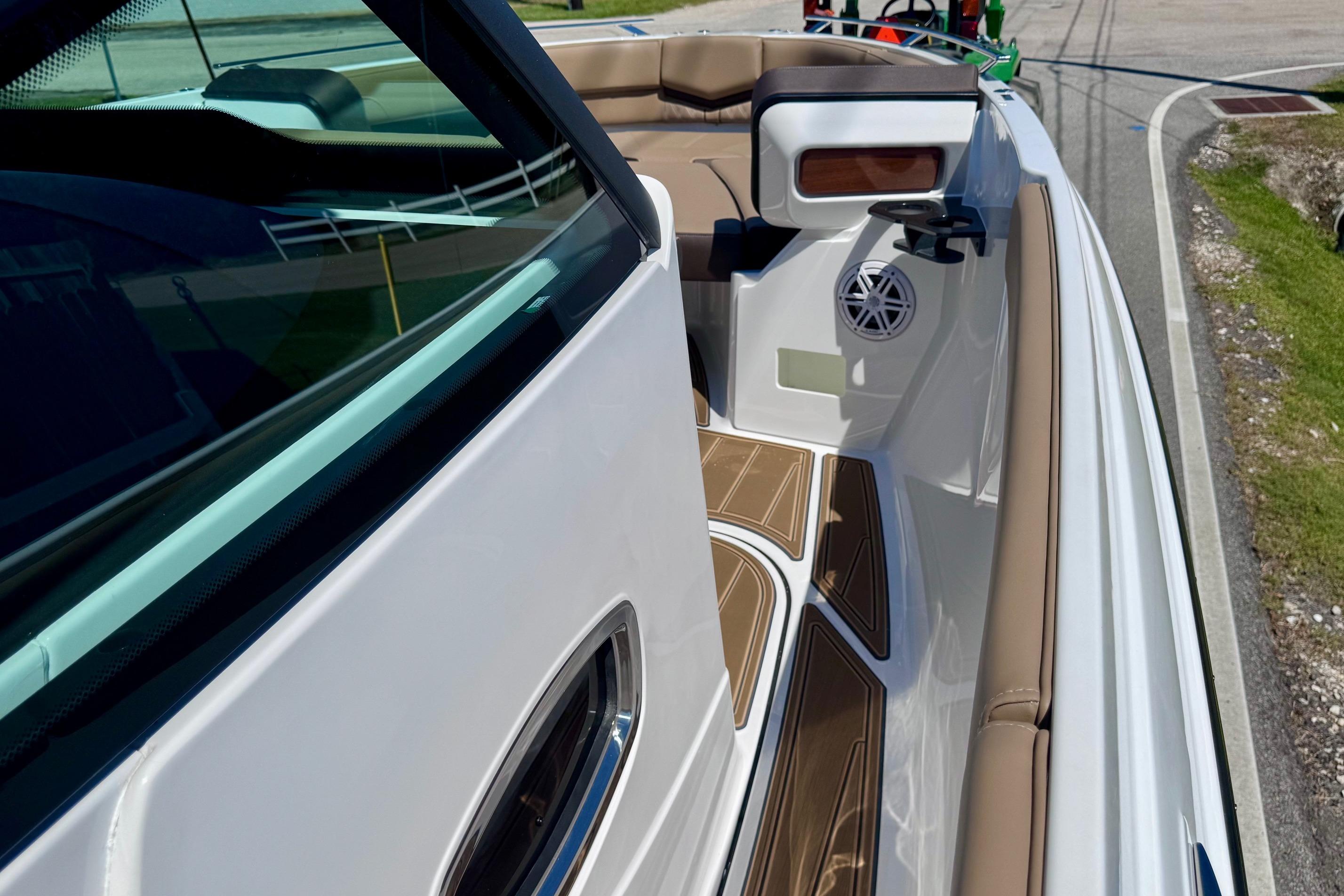 2026 Monterey Elite 27 OB boat interior with tan seating and modern design.