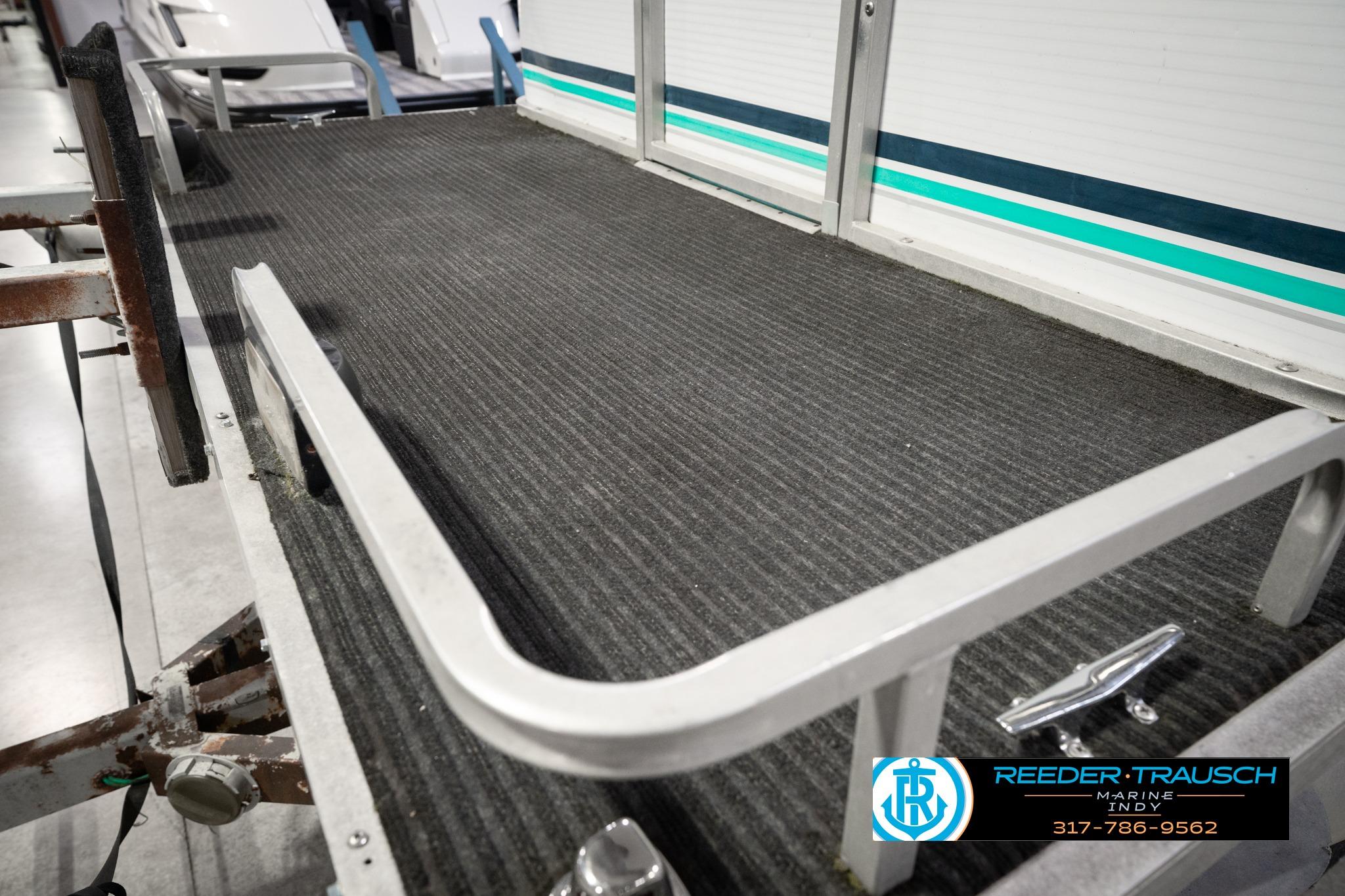 1992 Godfrey Sweetwater boat deck with textured flooring and railing, Reeder-Trausch Marine logo visible.
