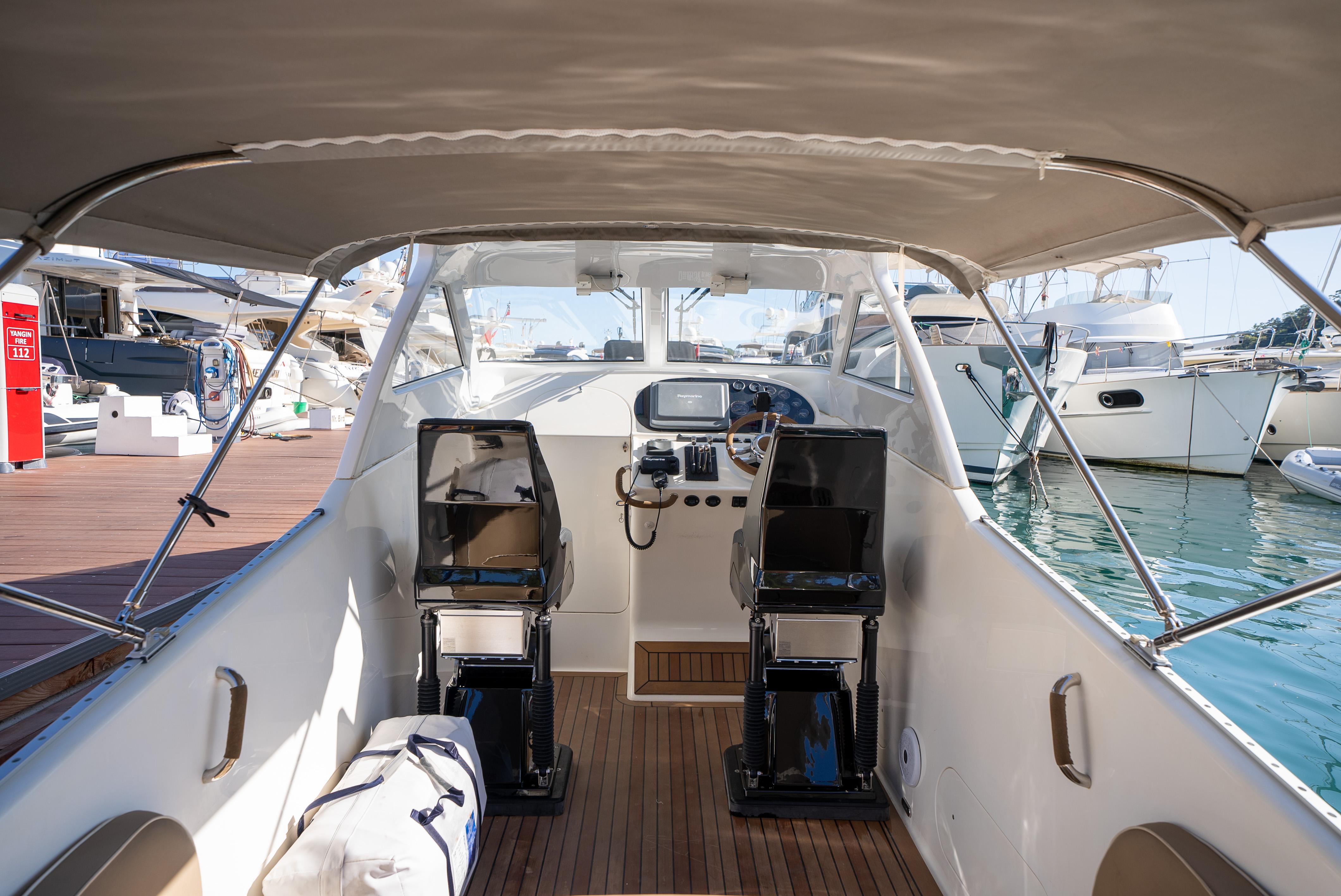 Interior view of 2009 Scorpion Sting boat with dual seats and control panel at marina.