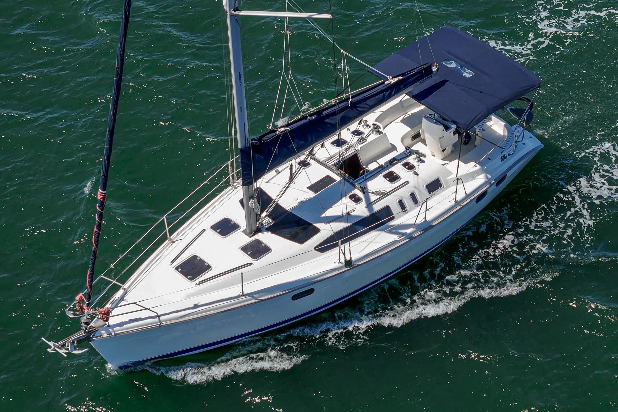 Sailing yacht Hunter 376, 1996 model, cruising on open water with white sails.