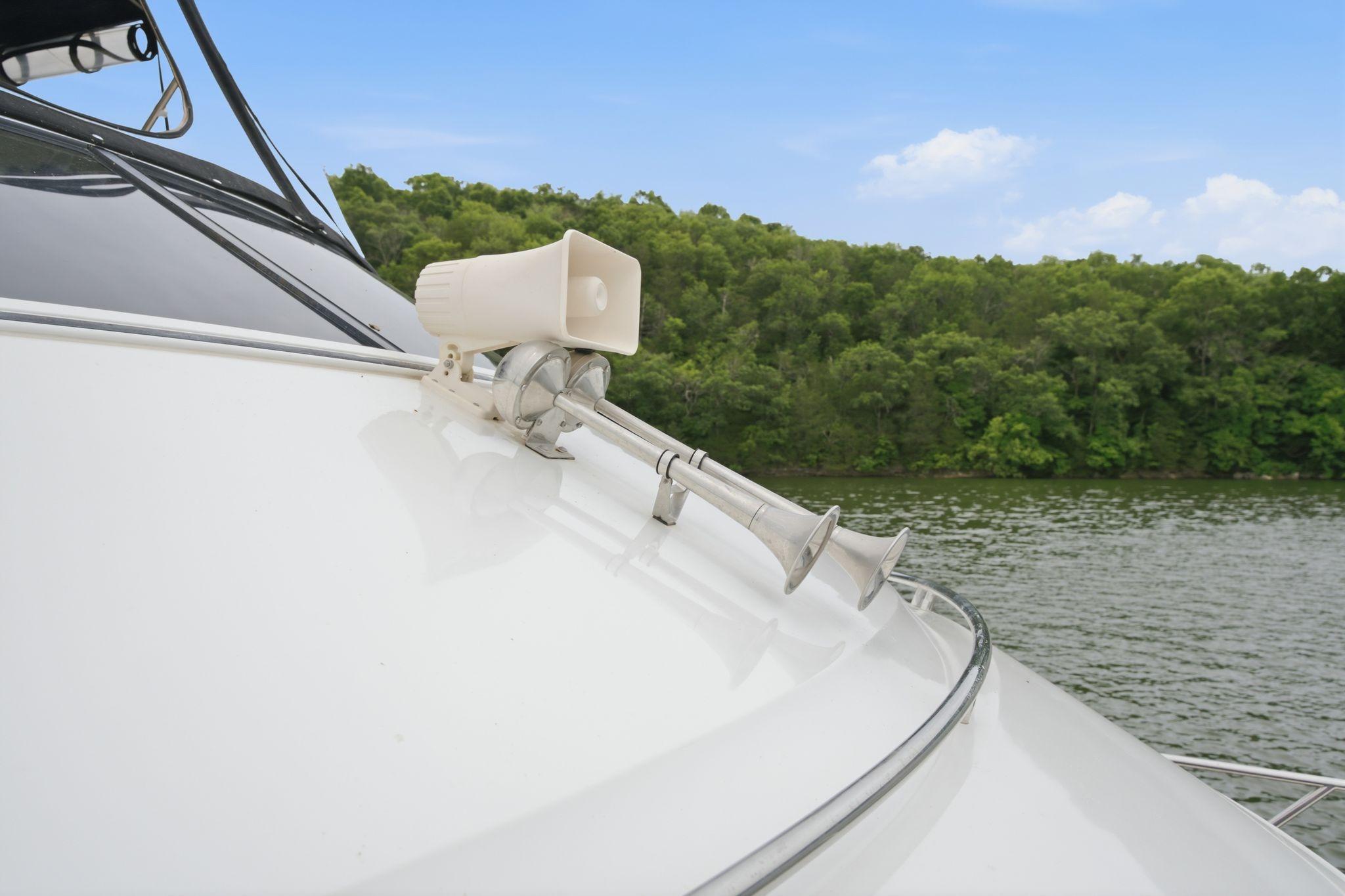 2005 Carver 39 Motor Yacht horn and speaker on deck, with scenic lake backdrop.