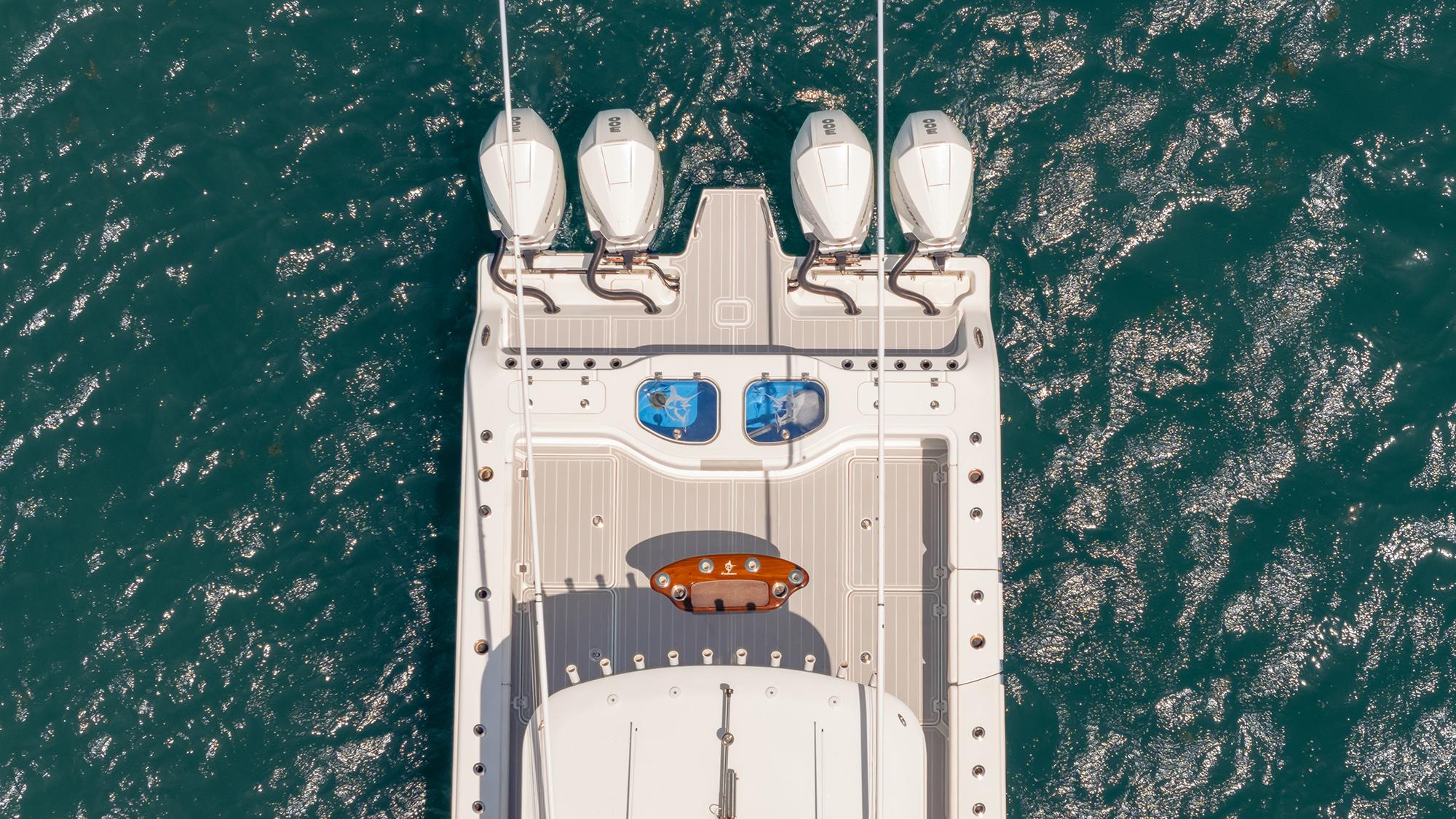 Aerial view of 2022 Freeman 43 boat with four engines on blue water.