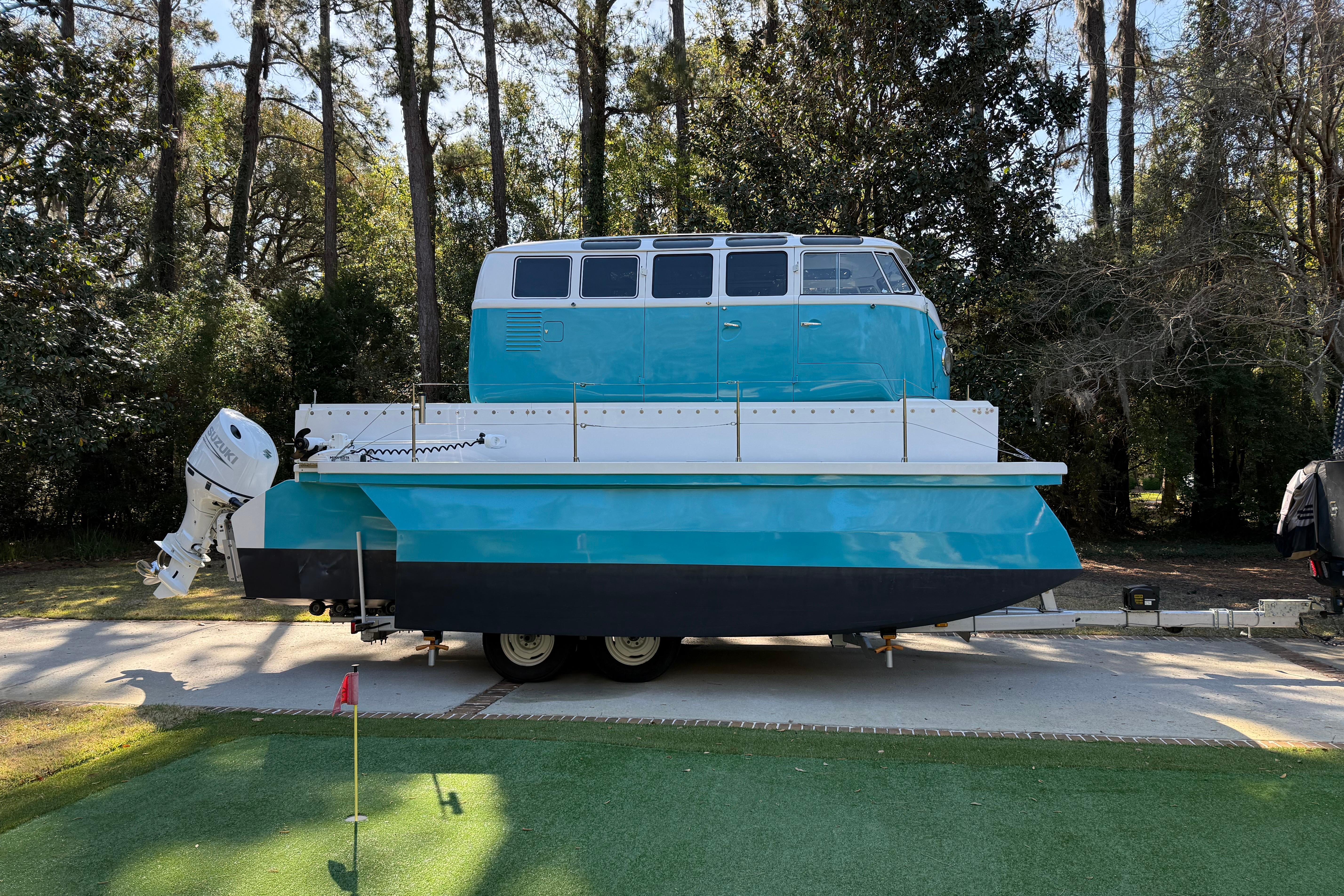 Custom 2024 Whitacre Yacht Design VW Bus Tritoon on trailer, parked outdoors.