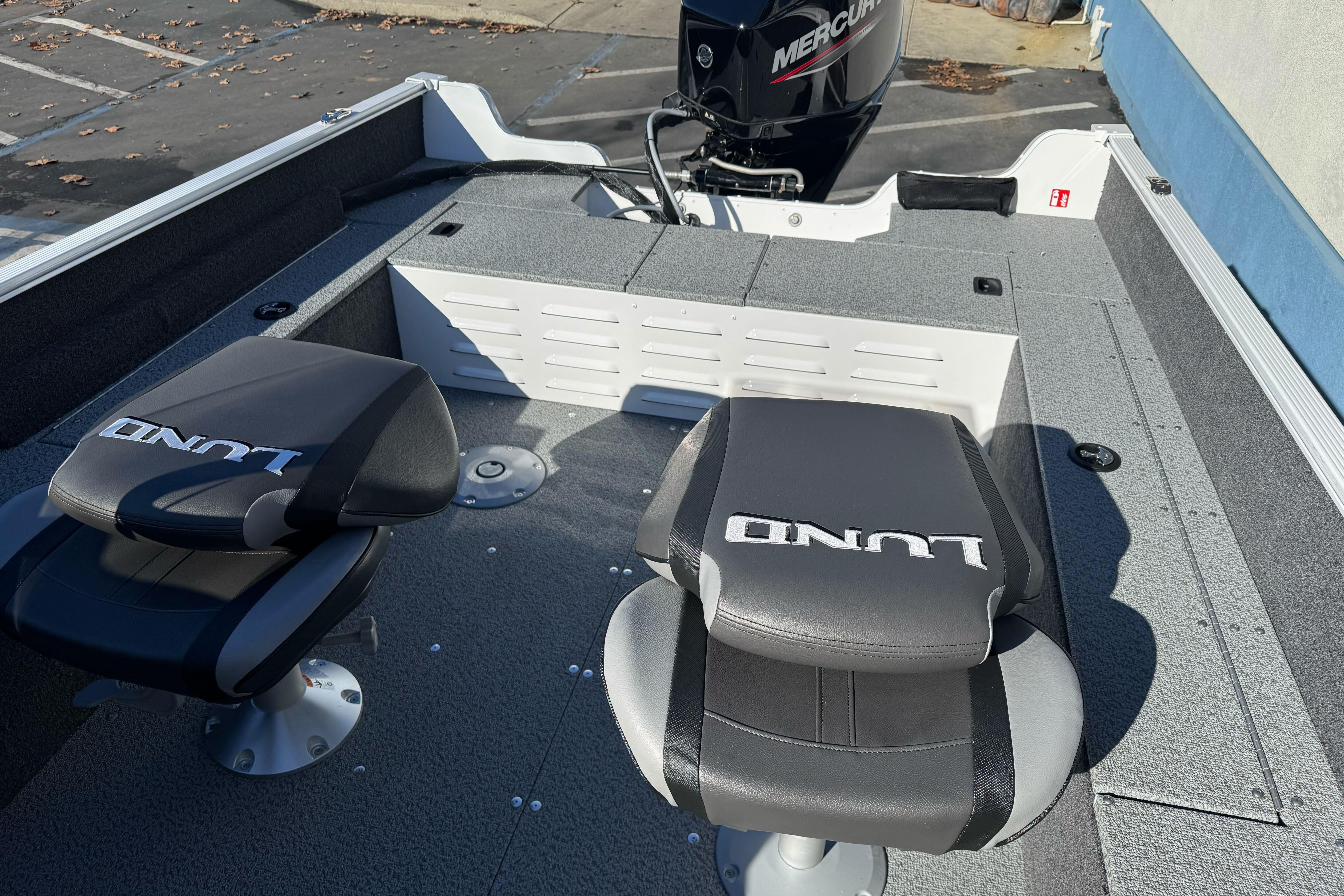 2026 Lund 1650 Angler SS boat interior with two seats and a Mercury engine.