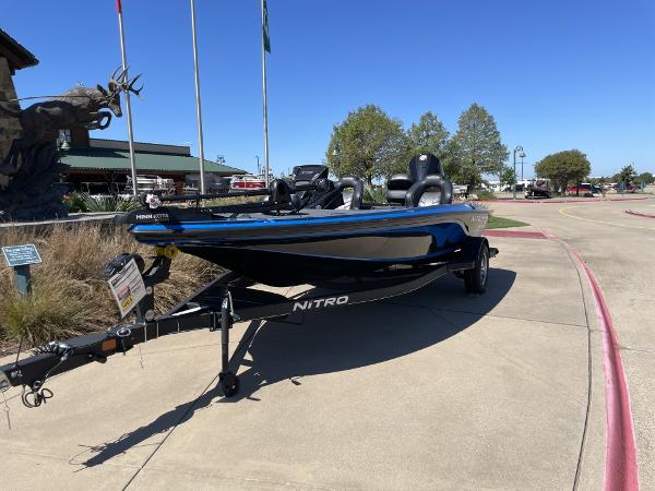 2024 Nitro Z19 boat on trailer, parked outdoors on sunny day.