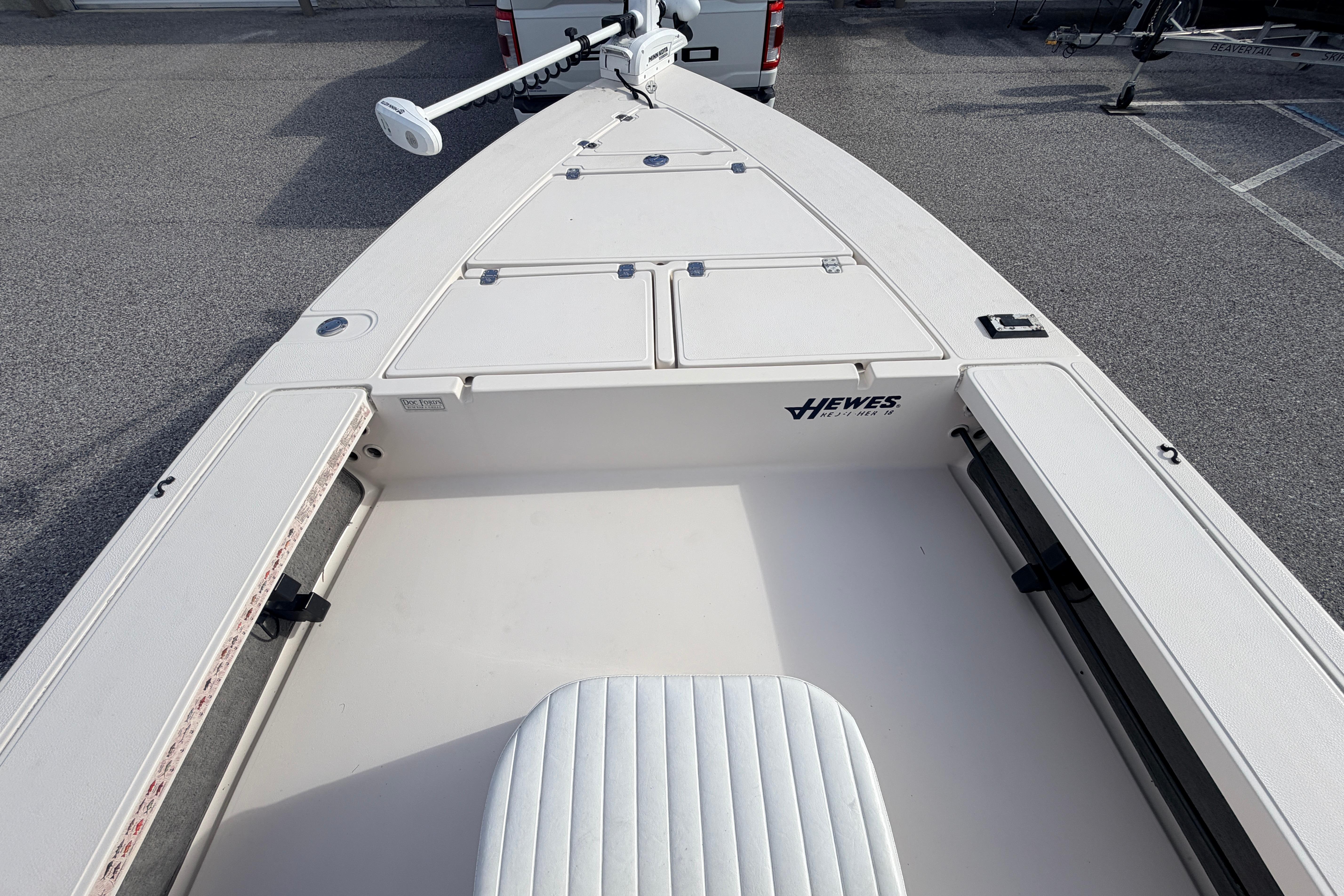 2004 Hewes Redfisher 18 boat interior with storage compartments and seating.