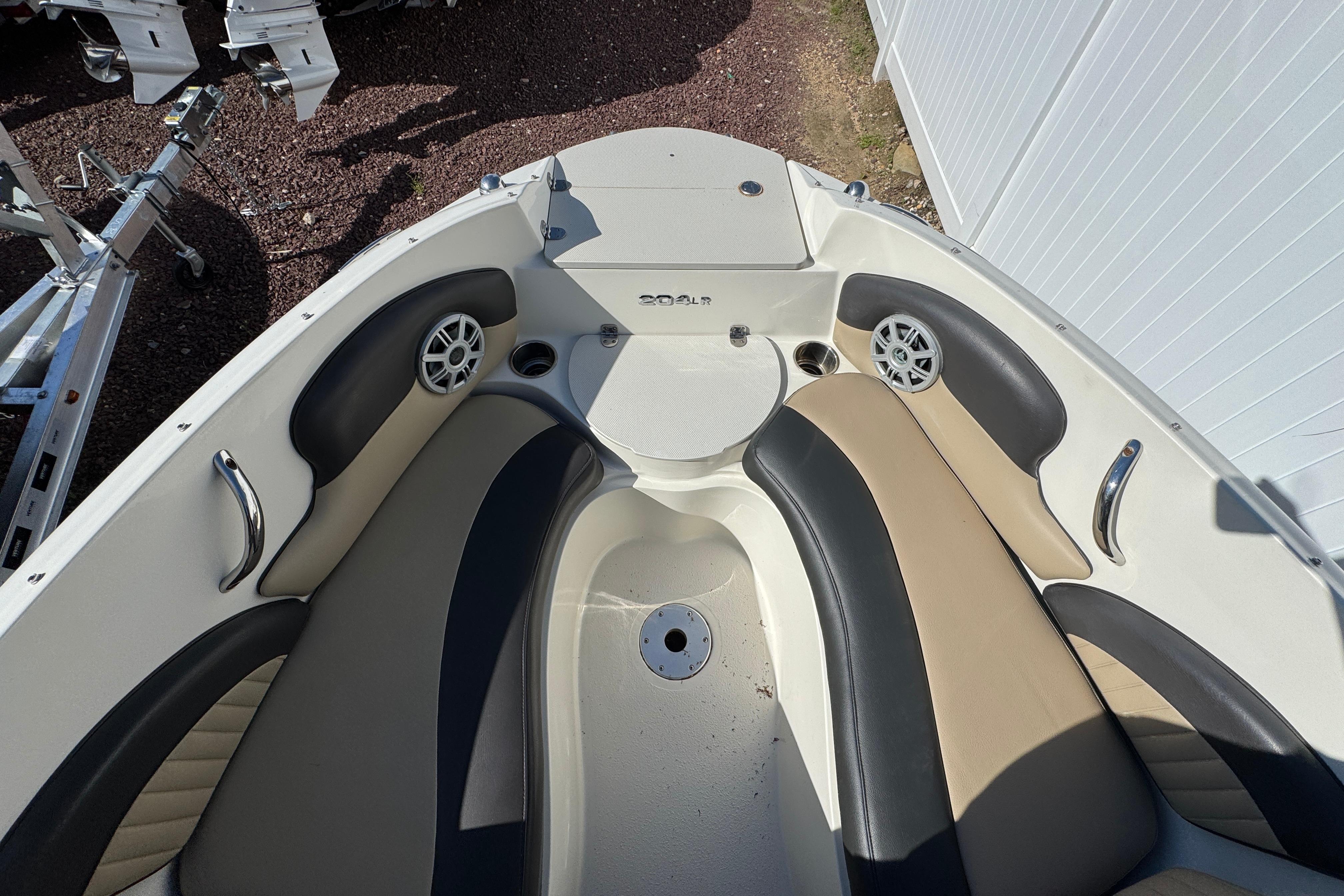 2018 Stingray 204 LR boat interior with cushioned seating and cup holders.