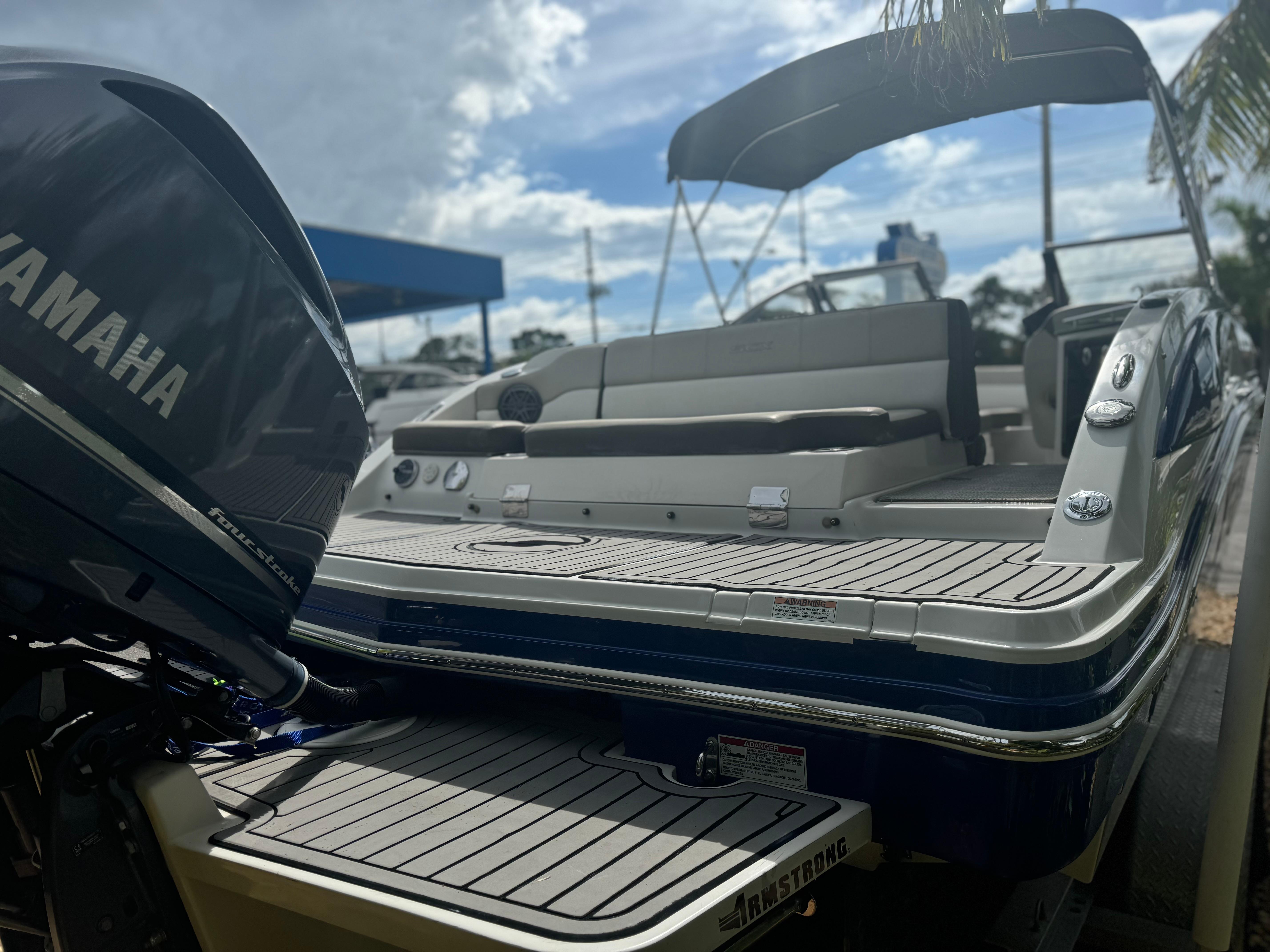 2017 Starcraft 230 OB SCX EXT boat with Yamaha engine, docked under a sunny sky.