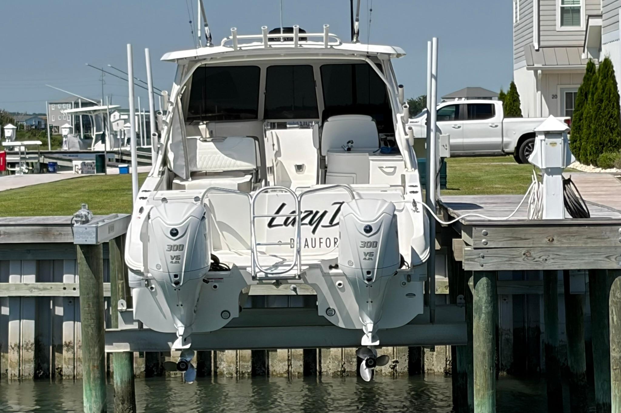 2022 World Cat 325 DC boat docked with twin 300 V6 engines.