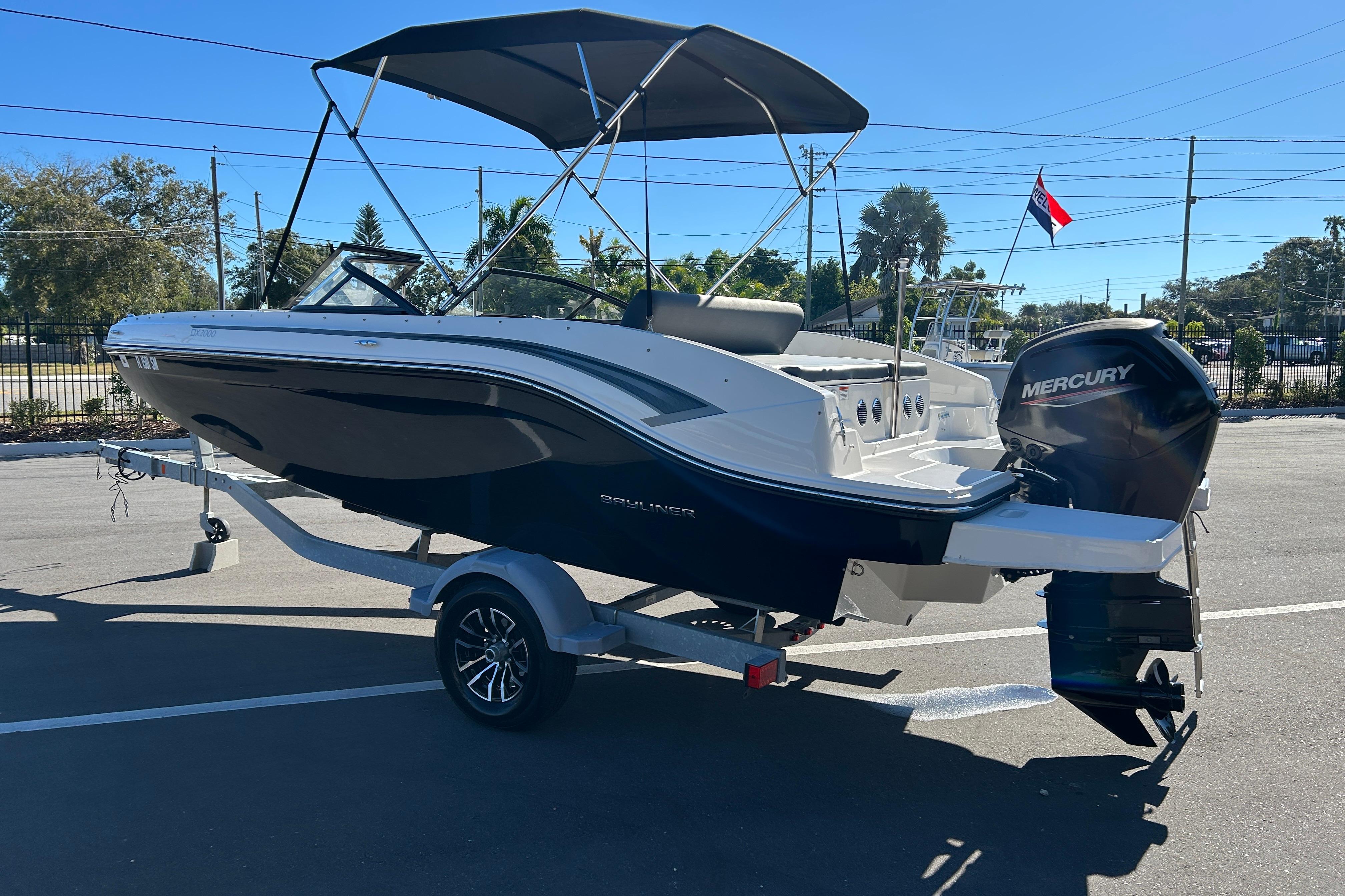 2020 Bayliner DX 2000 boat with Mercury outboard motor on a trailer.