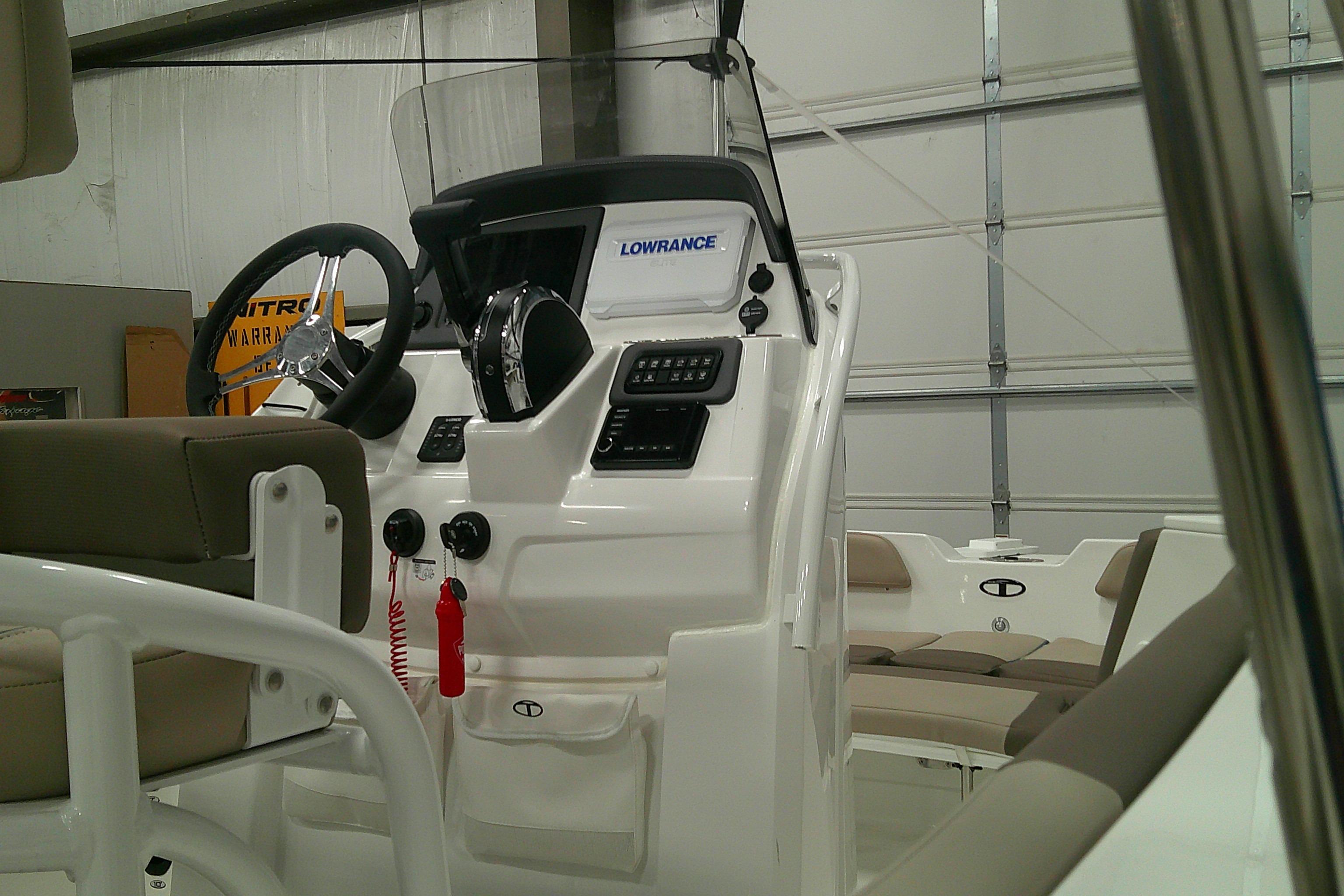 2026 Tahoe 2150 CC boat console with steering wheel and navigation equipment.